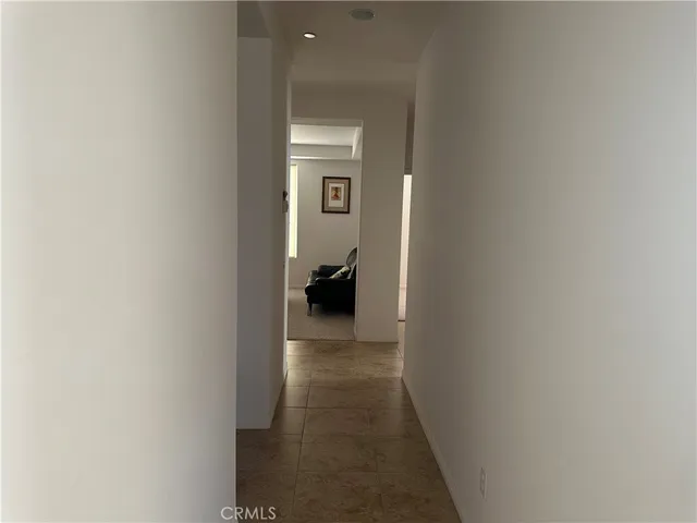 a view of a hallway with a room that has a couch