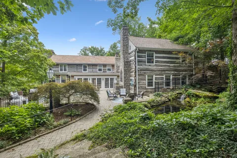 a aerial view of a house next to a yard