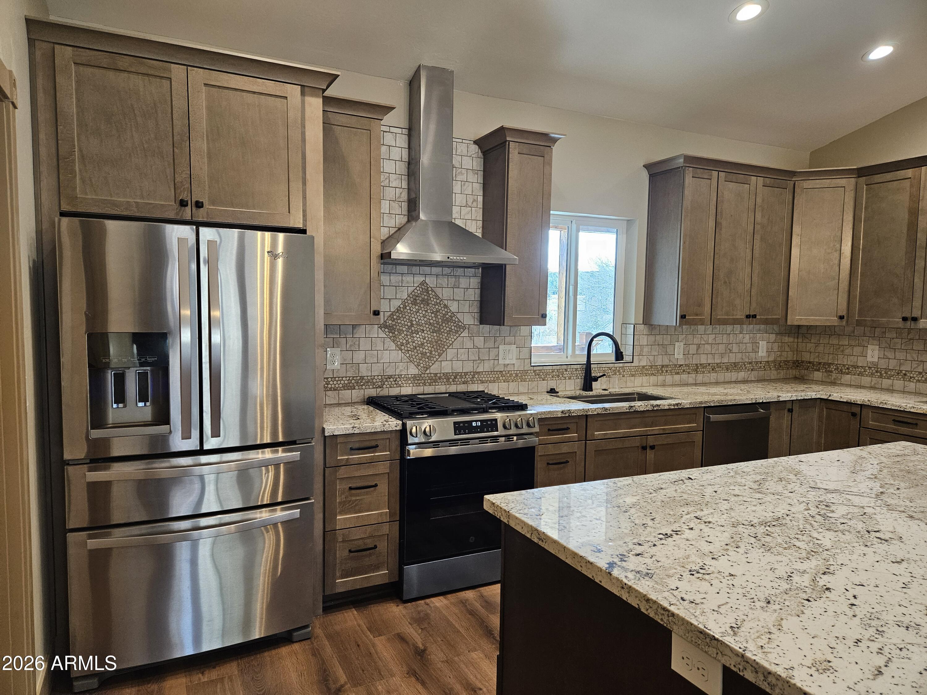 1380 Lakeside Trail Show Low, AZ 85901 - Photo 12 of 48 a kitchen with kitchen island granite countertop stainless steel appliances and wooden cabinets