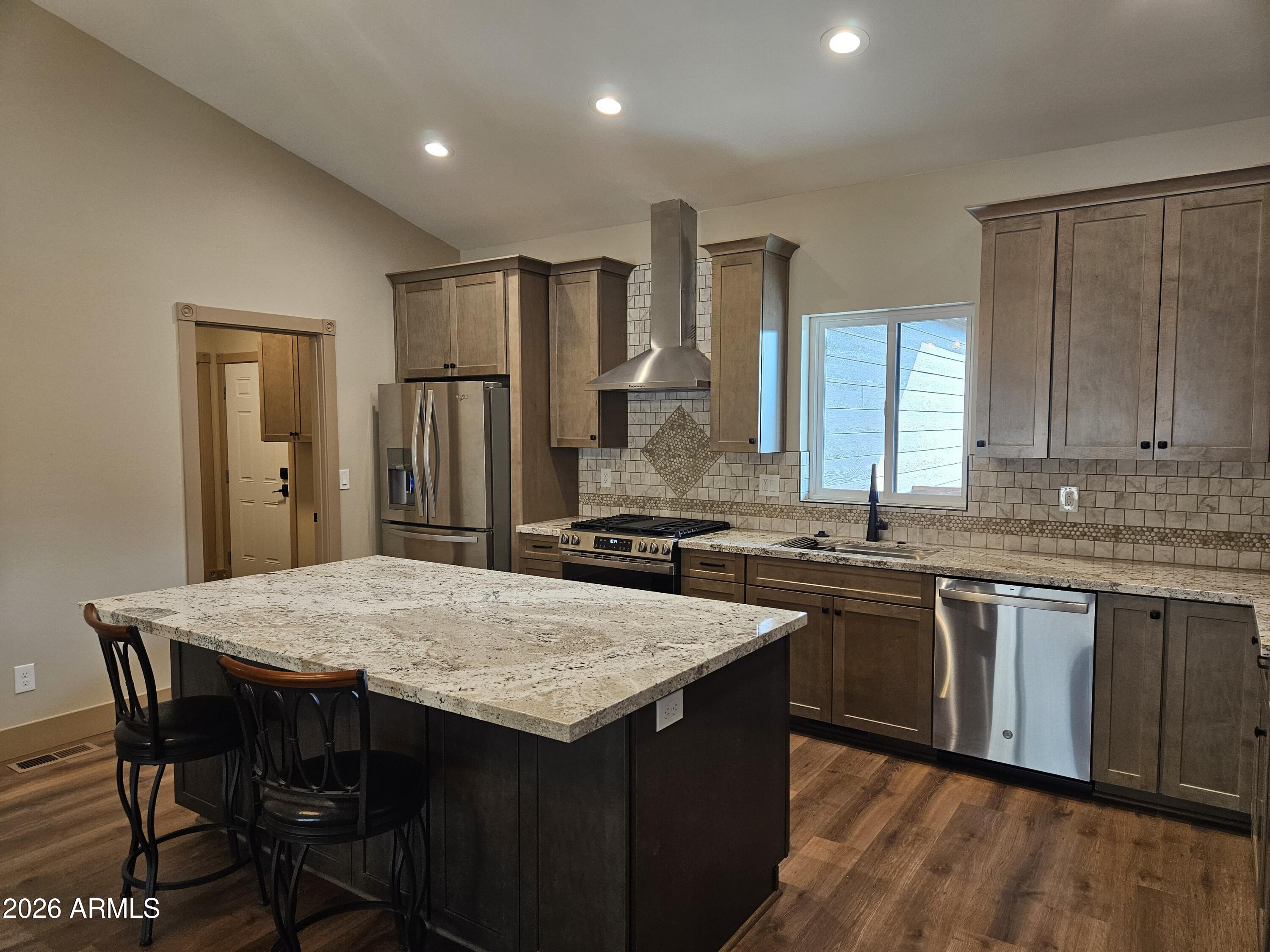 1380 Lakeside Trail Show Low, AZ 85901 - Photo 14 of 48 a kitchen with granite countertop a sink and wooden cabinets