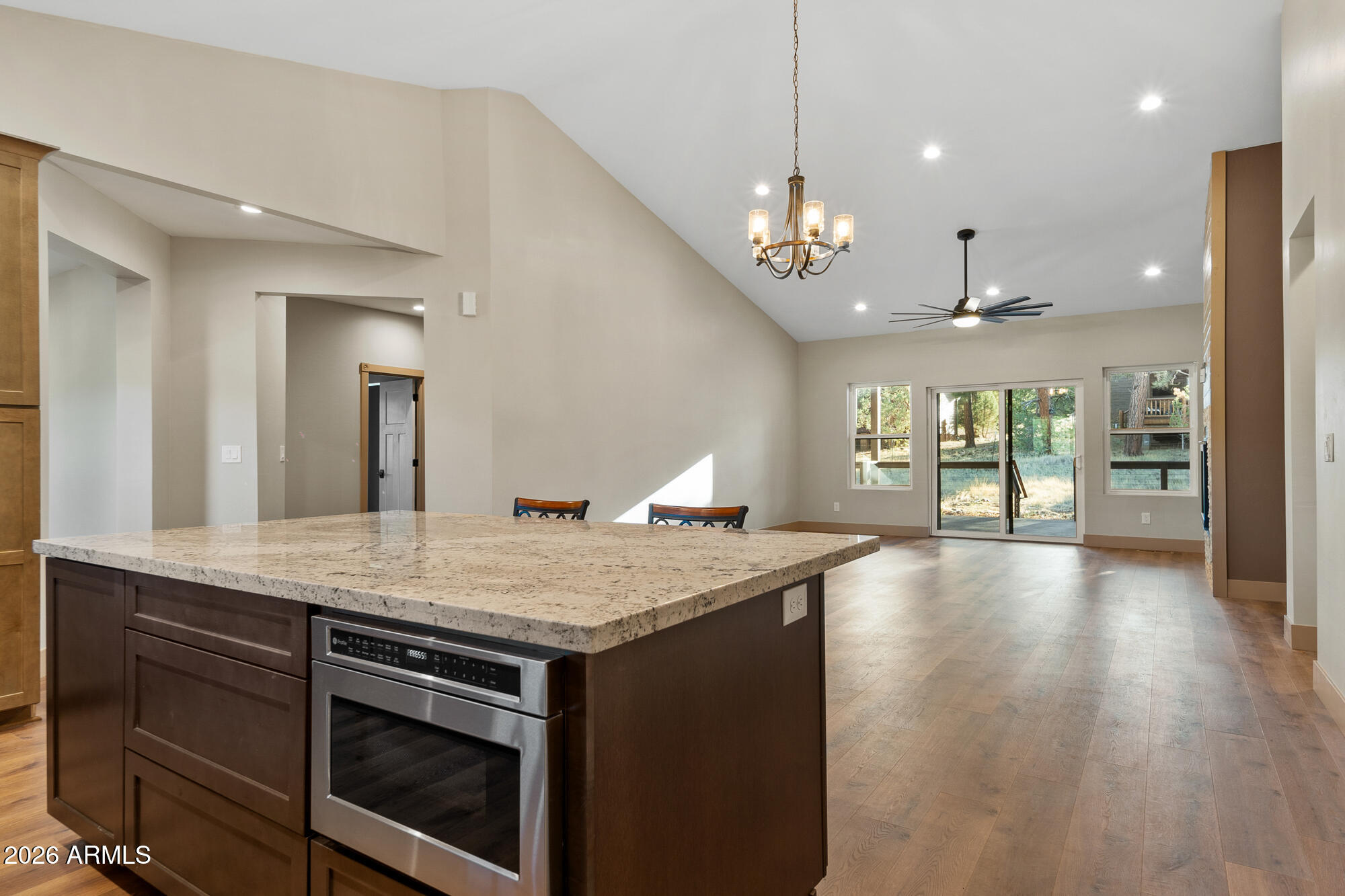 1380 Lakeside Trail Show Low, AZ 85901 - Photo 15 of 48 a open kitchen with a stove a sink dishwasher a dining table and chairs with wooden floor