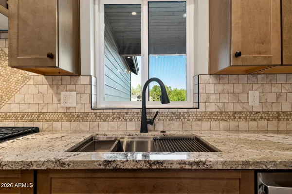 a view of a livingroom with wooden floor and furniture