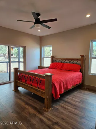 a view of backyard with a large window and wooden floor