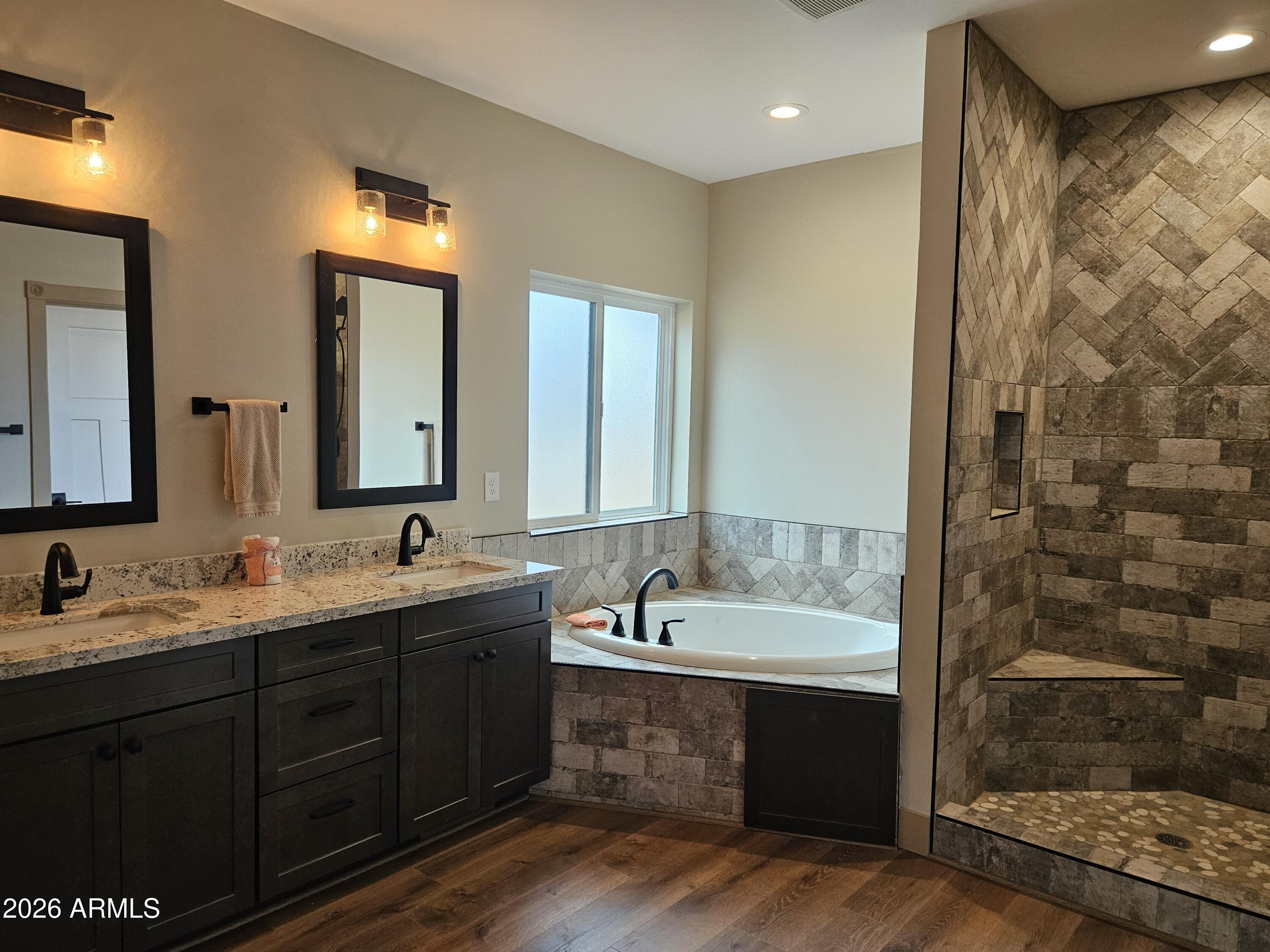 1380 Lakeside Trail Show Low, AZ 85901 - Photo 24 of 48 a bathroom with a double vanity sink a mirror and a bathtub
