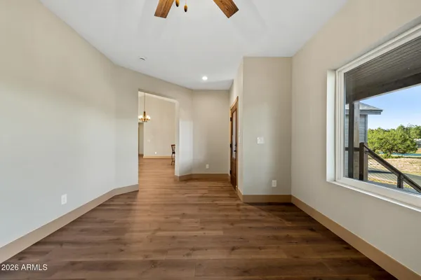 a view of a livingroom with a fireplace and a ceiling fan