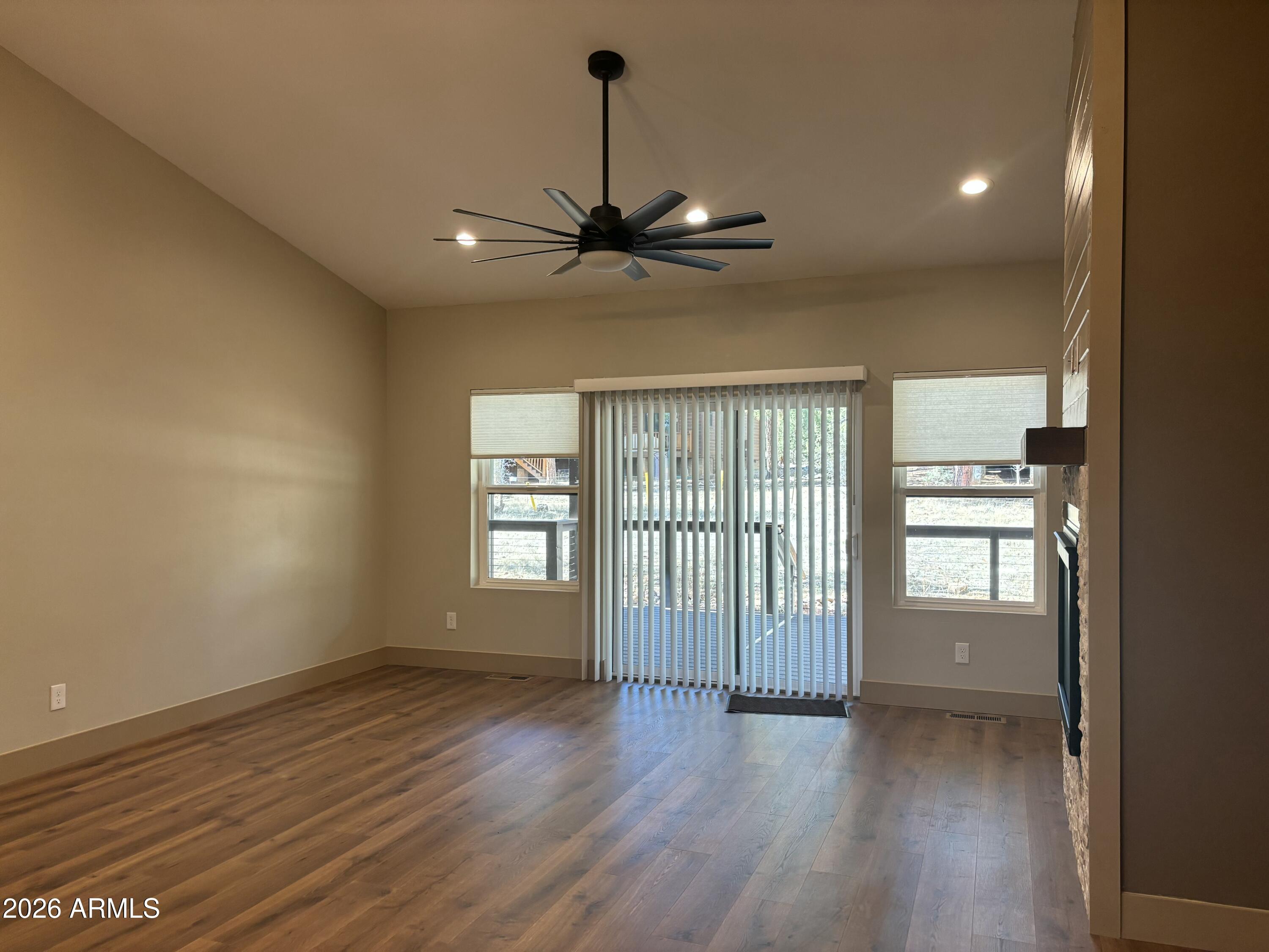1380 Lakeside Trail Show Low, AZ 85901 - Photo 10 of 48 a view of an empty room with window and wooden floor