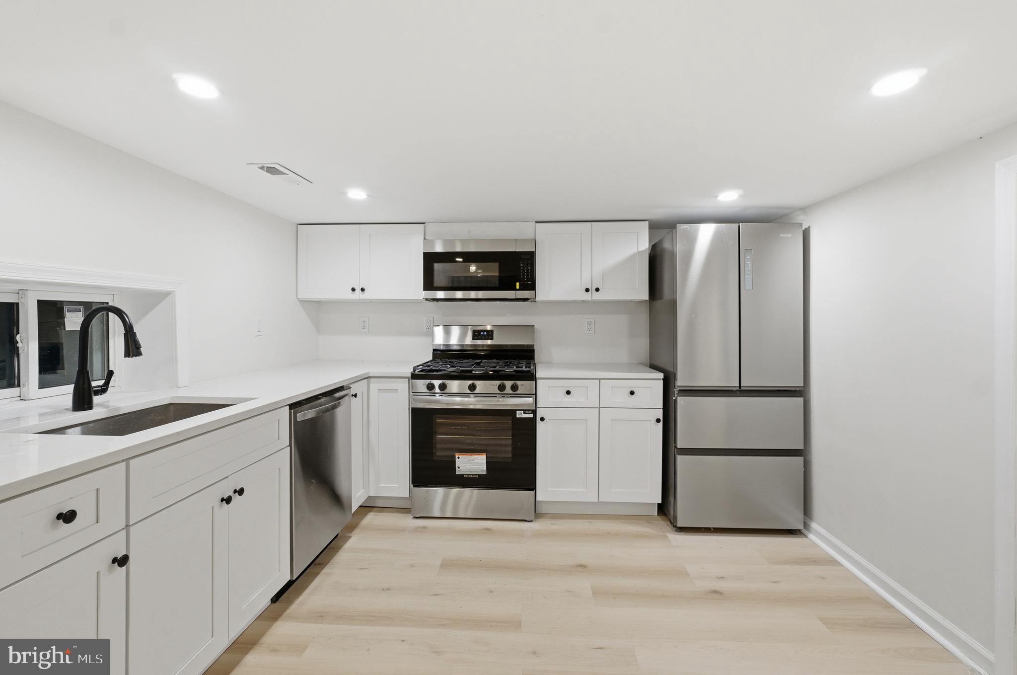 1 Beach Road Glen Burnie, MD 21060 - Photo 13 of 54 a kitchen with stainless steel appliances a refrigerator sink and stove