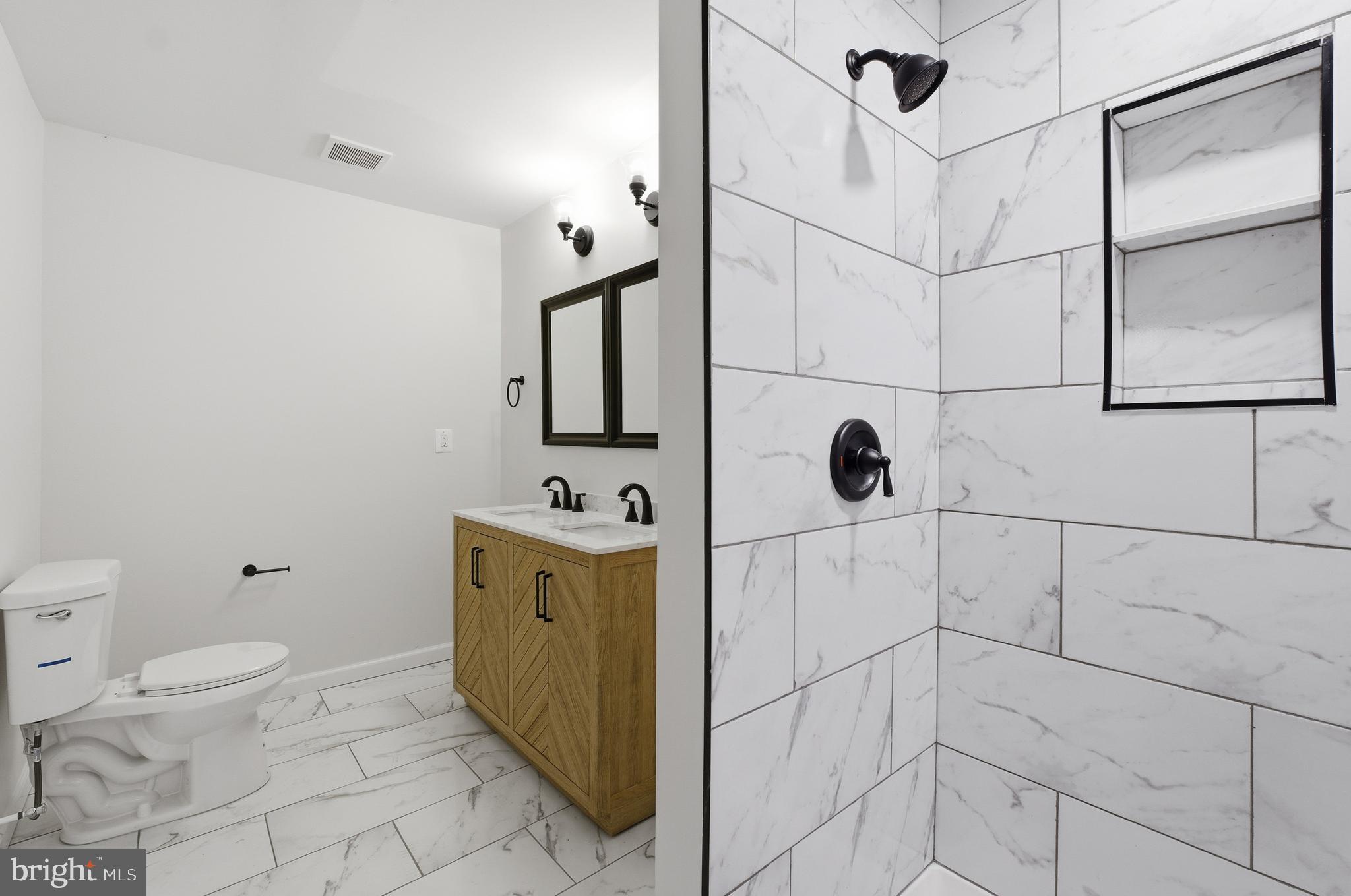 1 Beach Road Glen Burnie, MD 21060 - Photo 19 of 54 a bathroom with a toilet and a shower