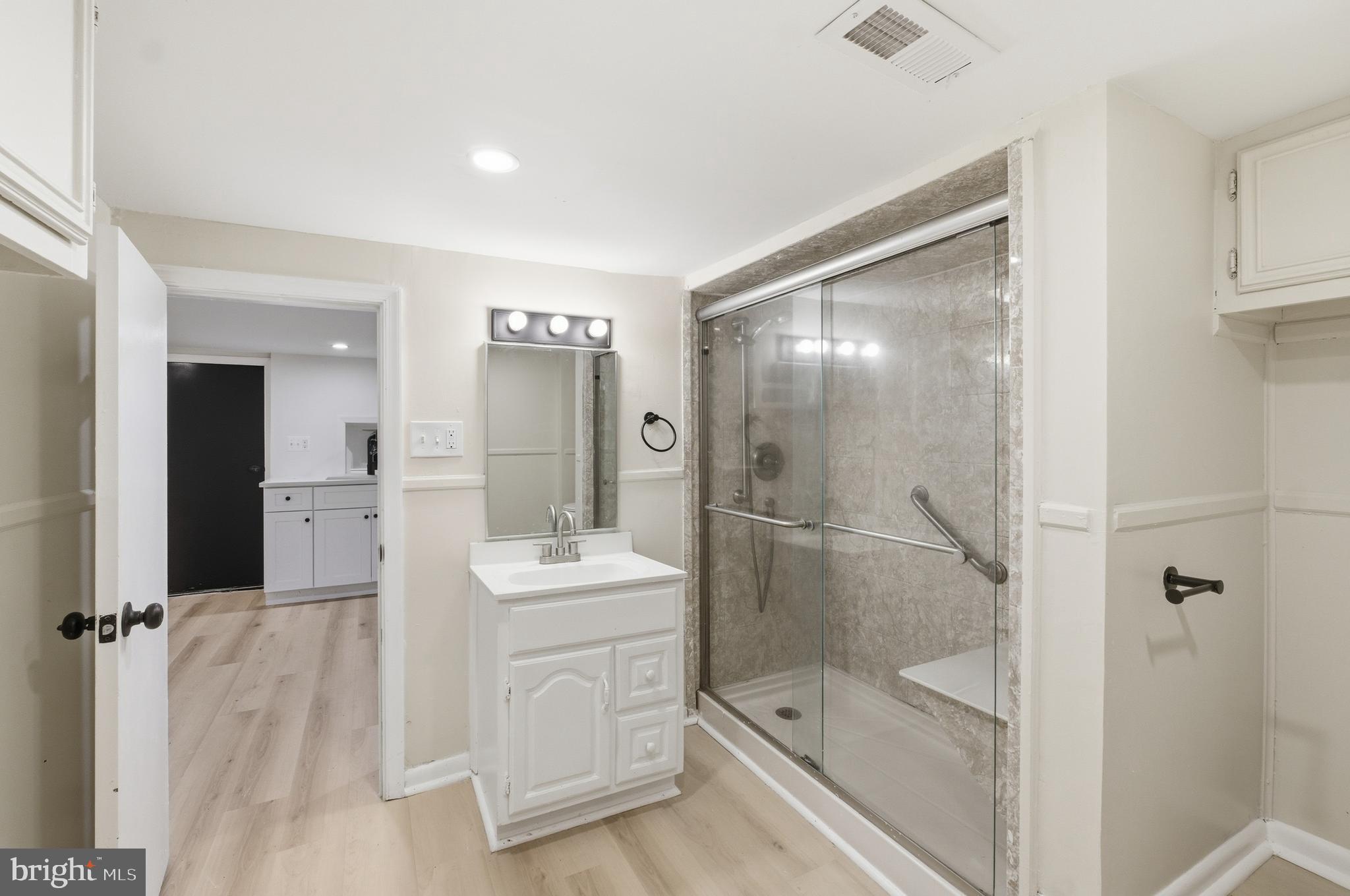 1 Beach Road Glen Burnie, MD 21060 - Photo 22 of 54 a bathroom with a shower sink and mirror