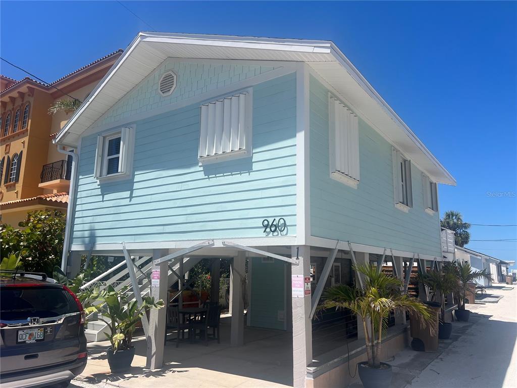 a view of a house with backyard and sitting area