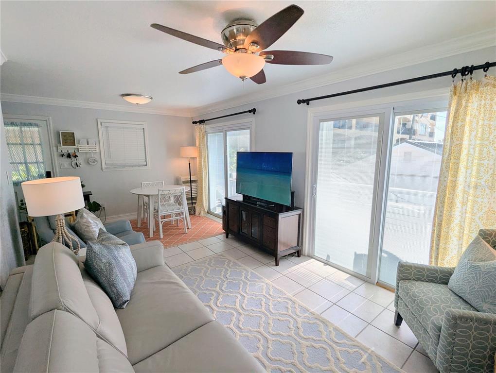960 Gulf Boulevard, Unit 1 Indian Rocks Beach, FL 33785 - Photo 11 of 15 a living room with furniture and a flat screen tv