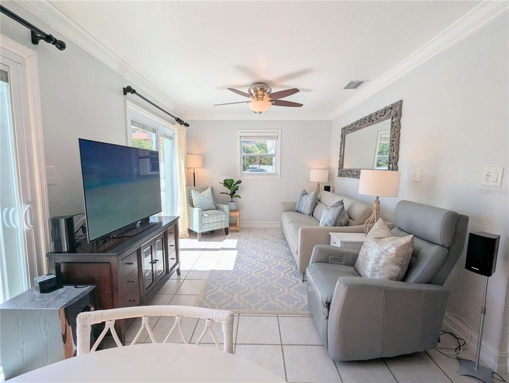 960 Gulf Boulevard, Unit 1 Indian Rocks Beach, FL 33785 - Photo 12 of 15 a living room with furniture and a flat screen tv
