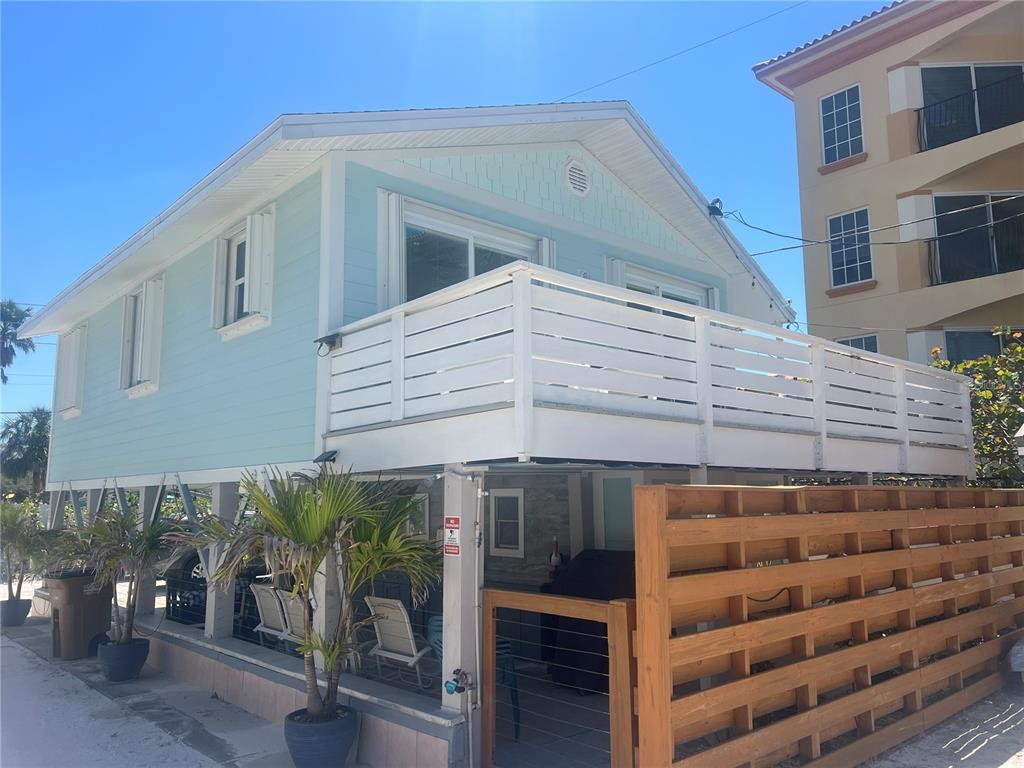 960 Gulf Boulevard, Unit 1 Indian Rocks Beach, FL 33785 - Photo 4 of 15 a front view of a building with glass windows