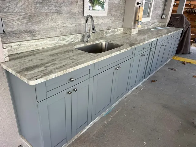 a kitchen with stainless steel appliances granite countertop a sink and a white stove