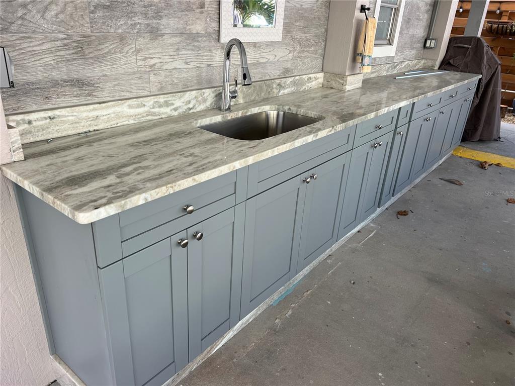 960 Gulf Boulevard, Unit 1 Indian Rocks Beach, FL 33785 - Photo 8 of 15 a kitchen with stainless steel appliances granite countertop a sink and a white stove