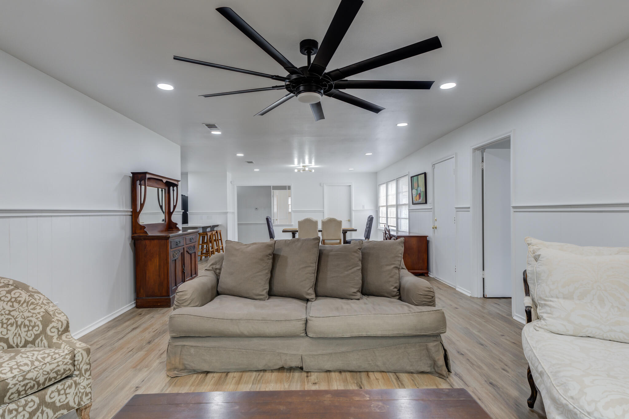 3023 66th Street Lubbock, TX 79413 - Photo 17 of 40 a living room with furniture a ceiling fan and a rug