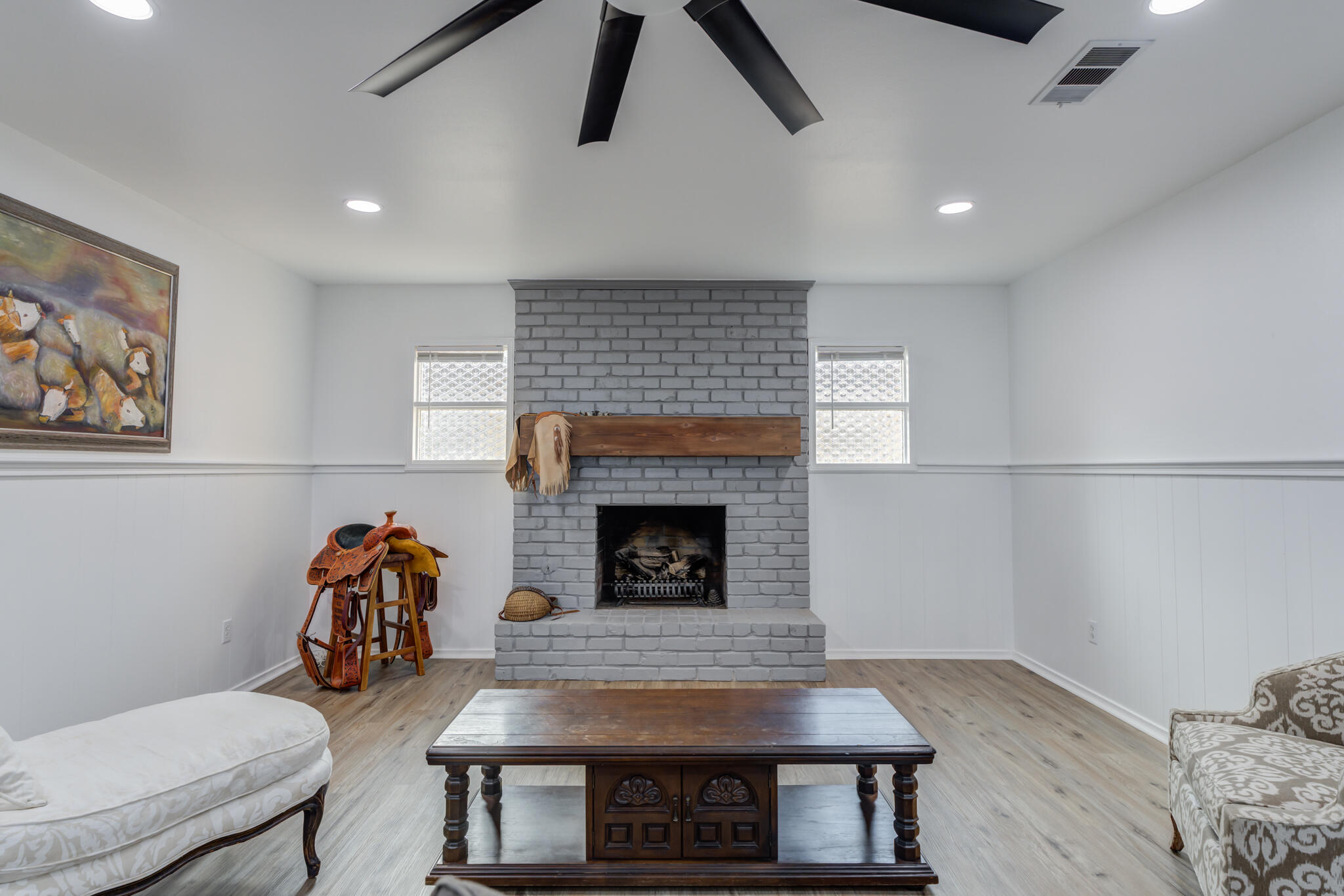 3023 66th Street Lubbock, TX 79413 - Photo 19 of 40 a living room with furniture and a fireplace