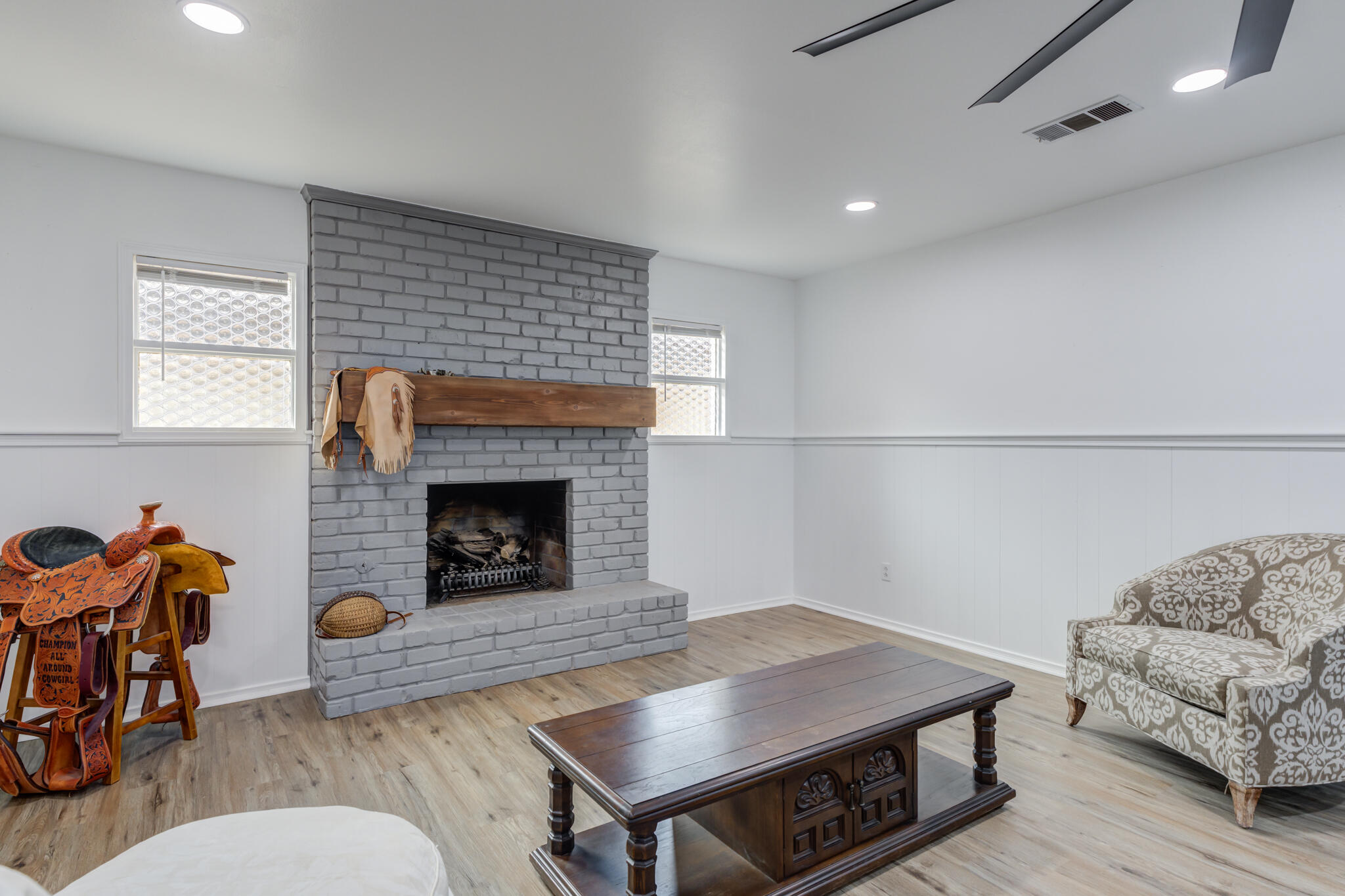 3023 66th Street Lubbock, TX 79413 - Photo 20 of 40 a living room with furniture and a fireplace