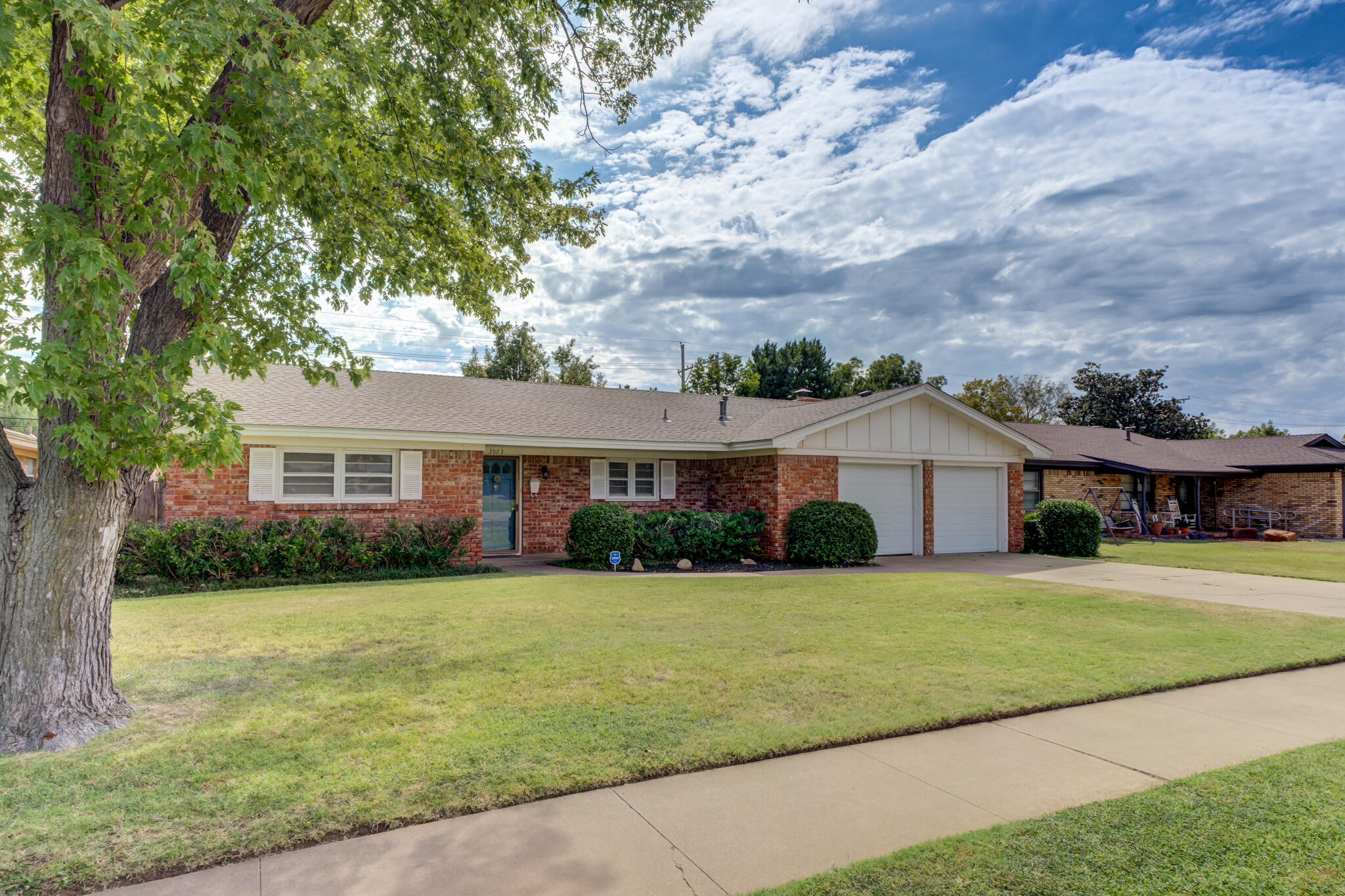 3023 66th Street Lubbock, TX 79413 - Photo 2 of 40 a view of a yard in front of a house