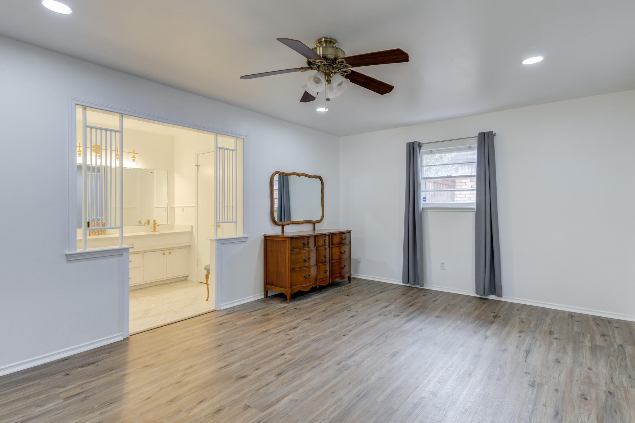 3023 66th Street Lubbock, TX 79413 - Photo 21 of 40 a view of workspace with wooden floor and windows