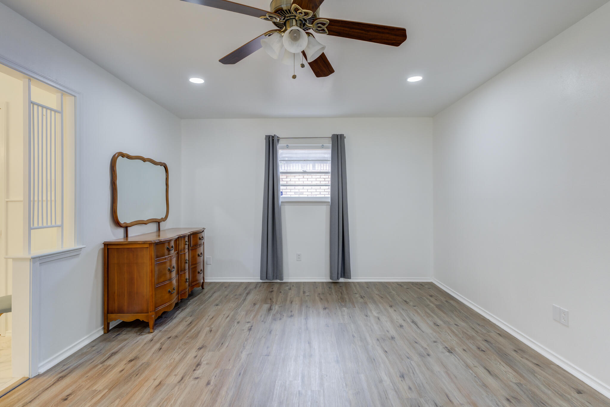 3023 66th Street Lubbock, TX 79413 - Photo 22 of 40 wooden floor in an empty room with a window