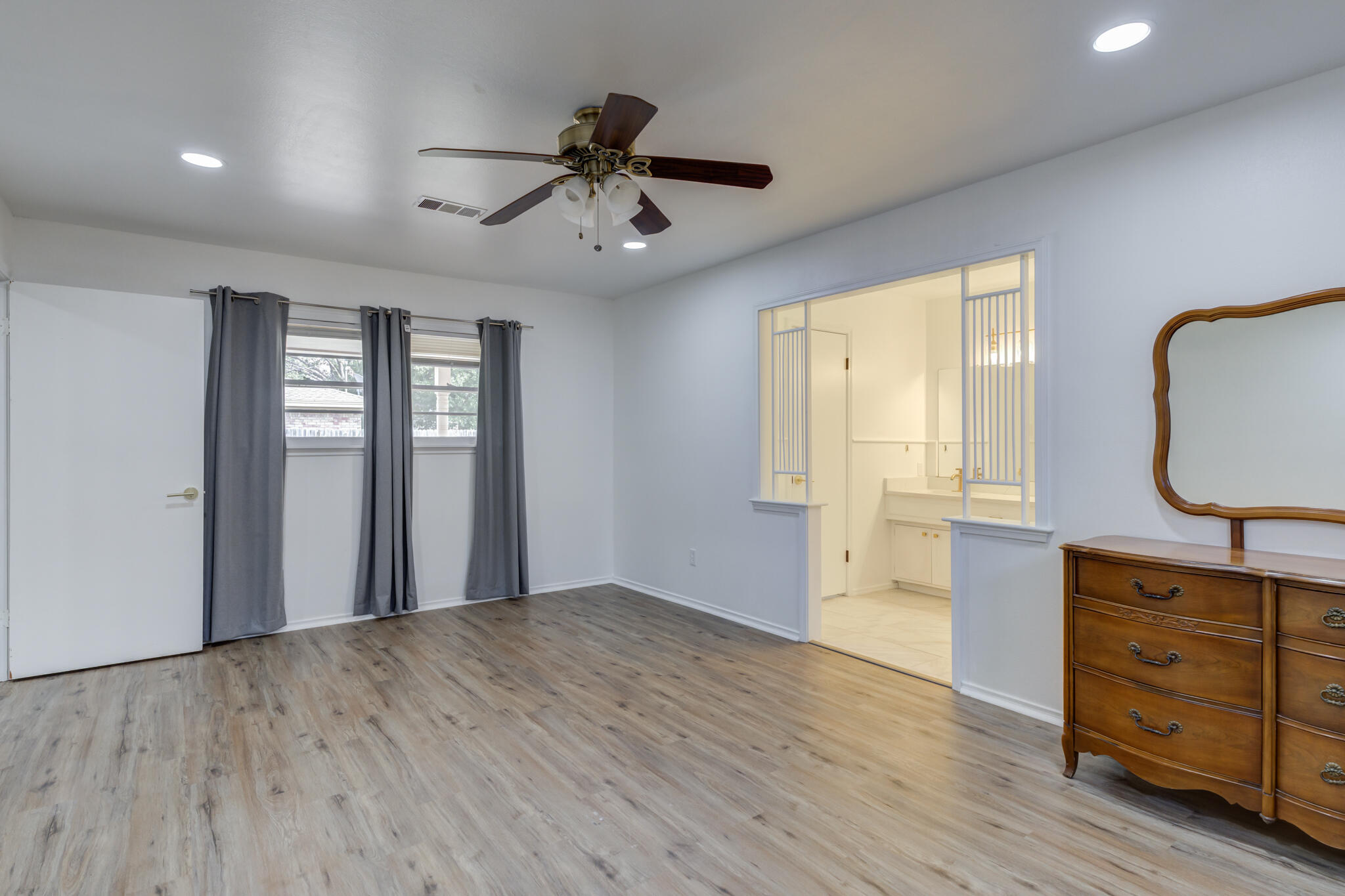 3023 66th Street Lubbock, TX 79413 - Photo 23 of 40 a view of an empty room with a window and dresser