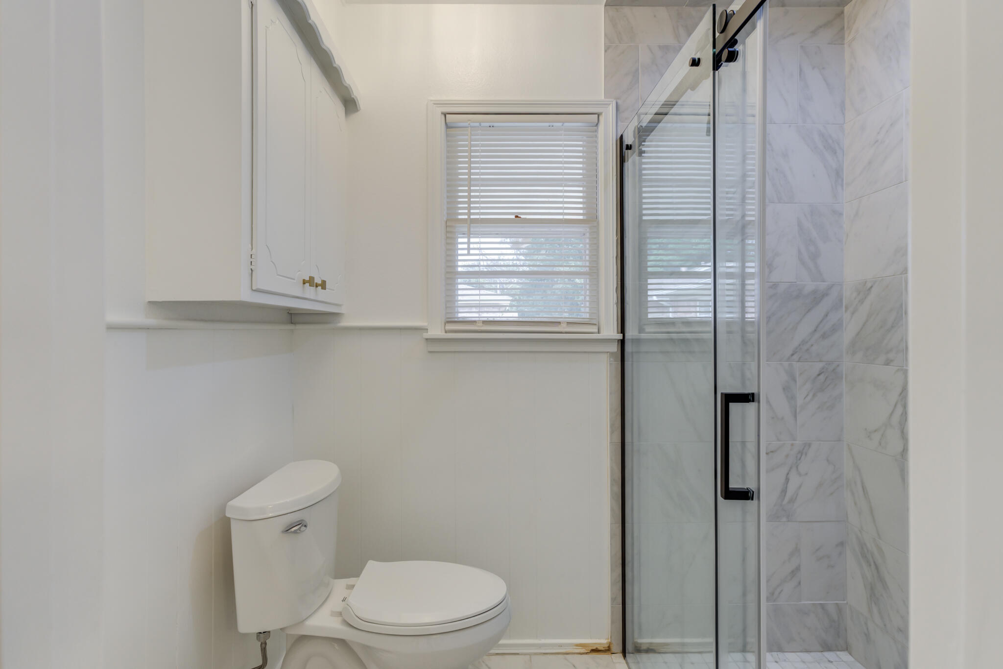 3023 66th Street Lubbock, TX 79413 - Photo 25 of 40 a bathroom with a toilet a sink and shower