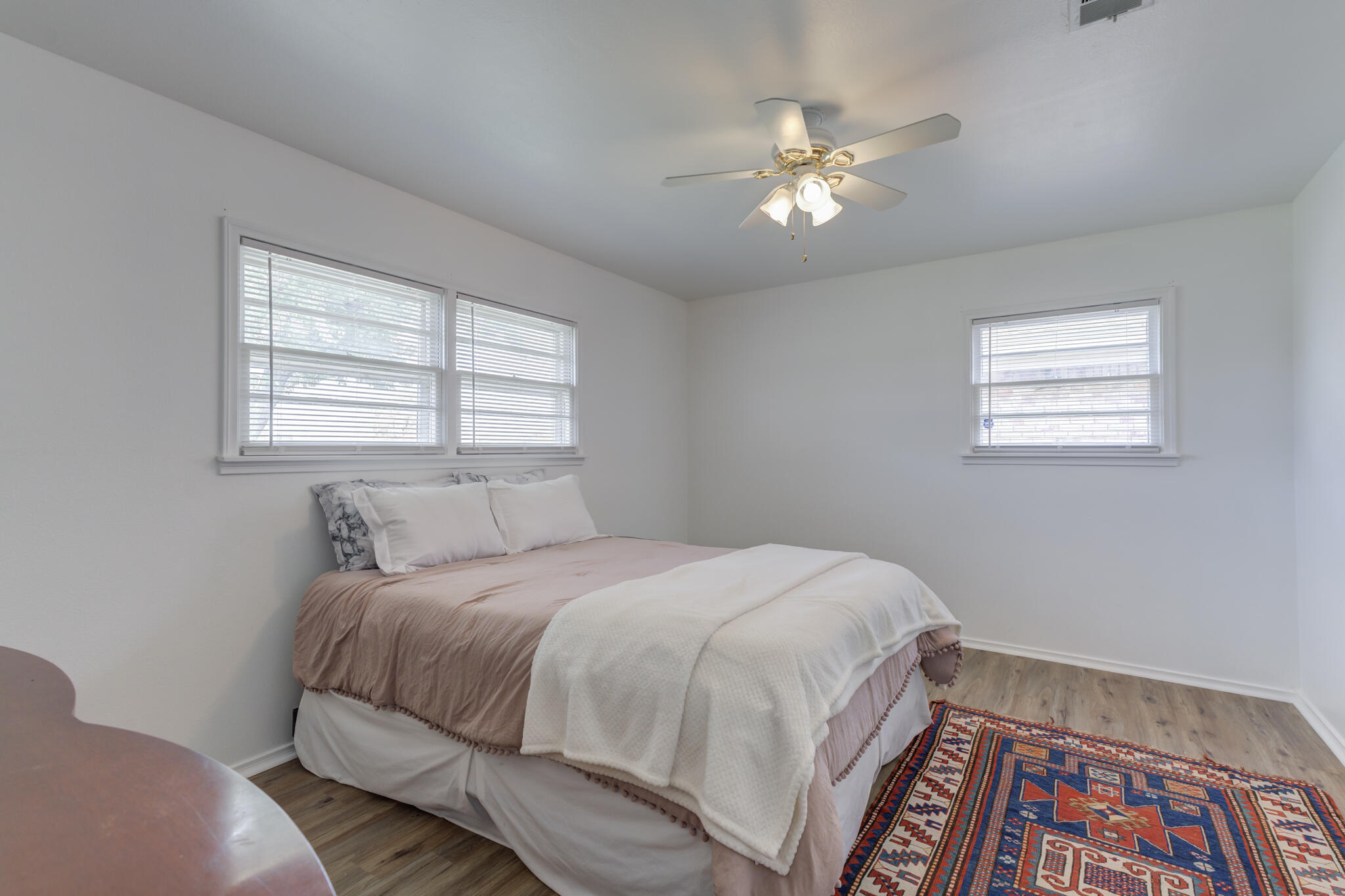 3023 66th Street Lubbock, TX 79413 - Photo 27 of 40 a bedroom with a bed and a chandelier