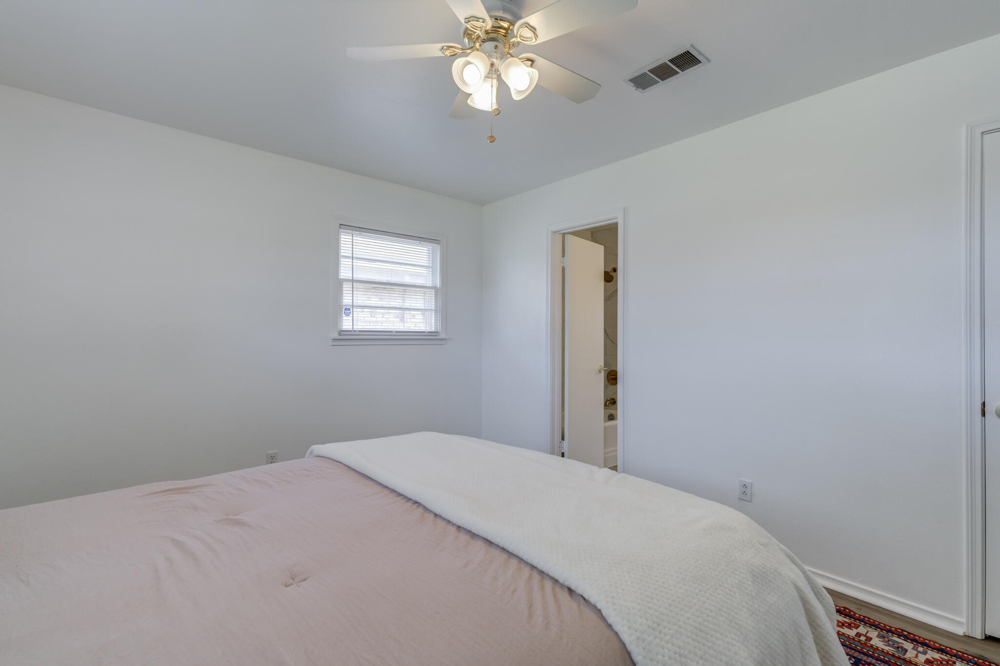 3023 66th Street Lubbock, TX 79413 - Photo 28 of 40 a bedroom with a bed and a chandelier