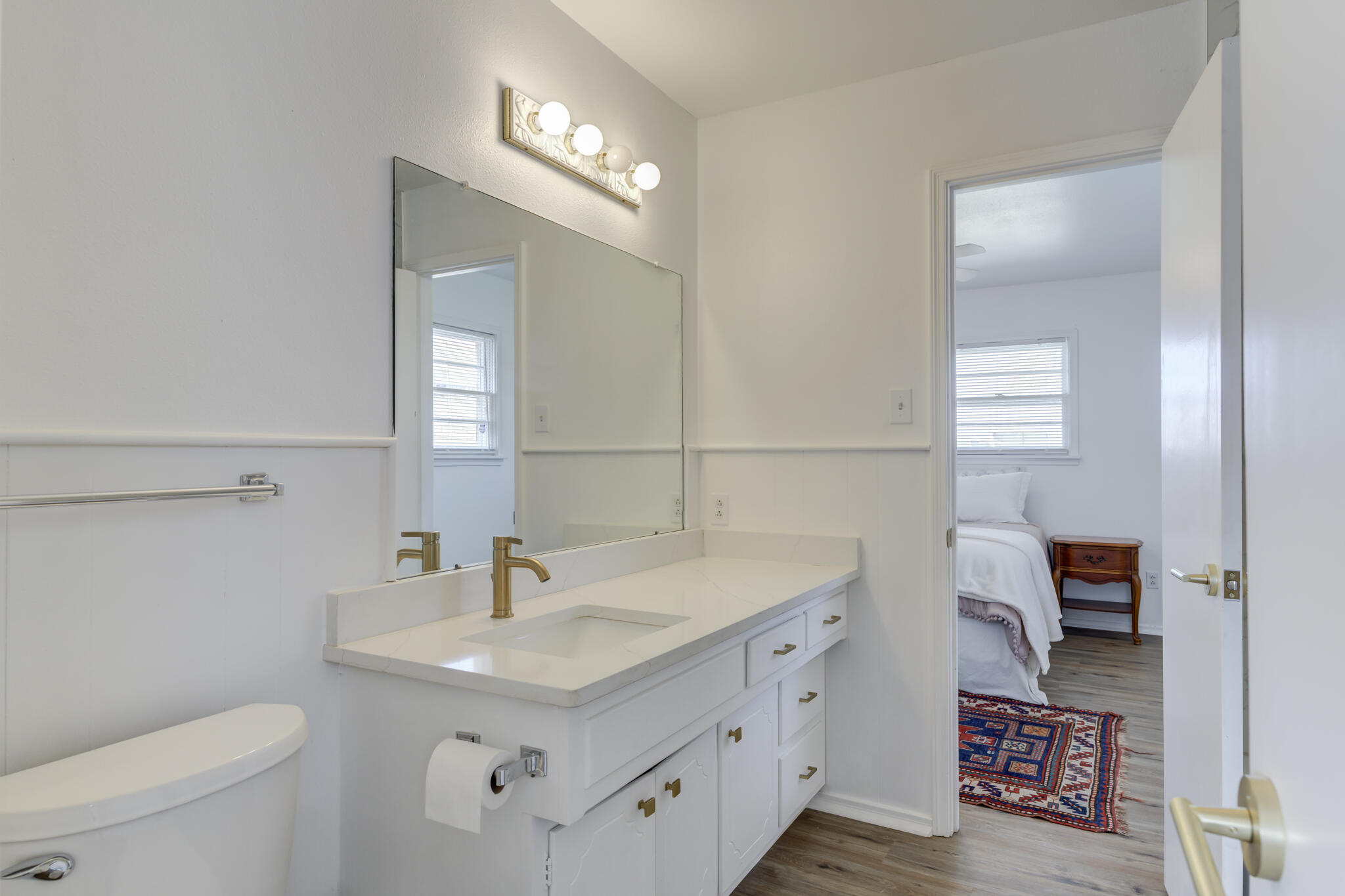 3023 66th Street Lubbock, TX 79413 - Photo 29 of 40 a bathroom with a sink a toilet and a mirror