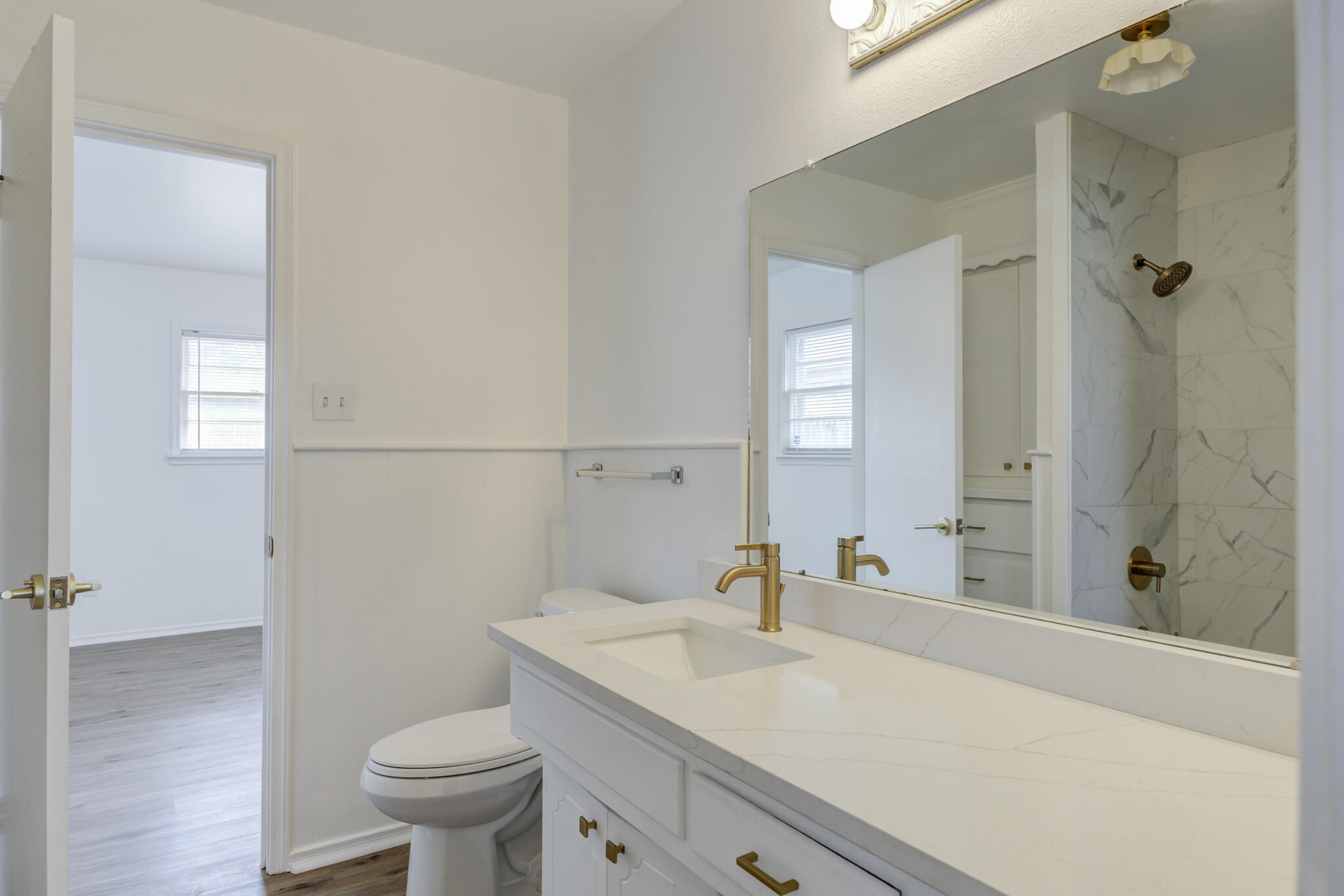 3023 66th Street Lubbock, TX 79413 - Photo 30 of 40 a bathroom with a sink a toilet and shower