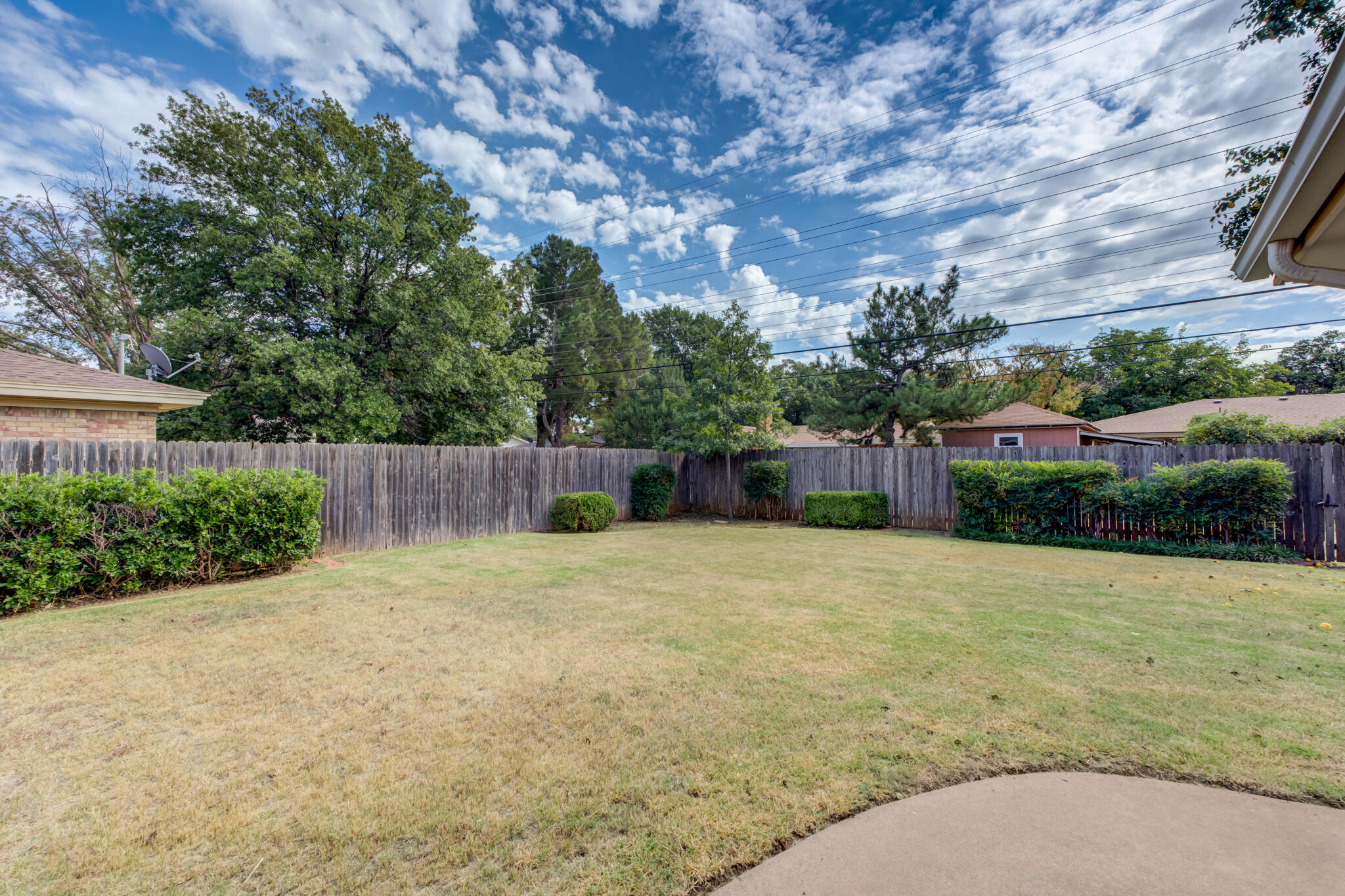 3023 66th Street Lubbock, TX 79413 - Photo 37 of 40 a backyard of a house with lots of green space