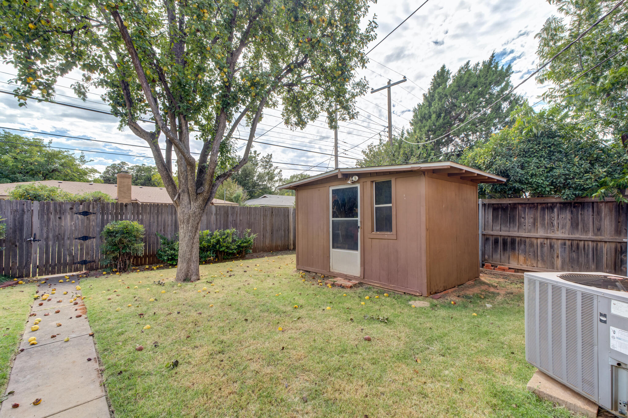 3023 66th Street Lubbock, TX 79413 - Photo 38 of 40 a view of backyard with wooden fence and large trees