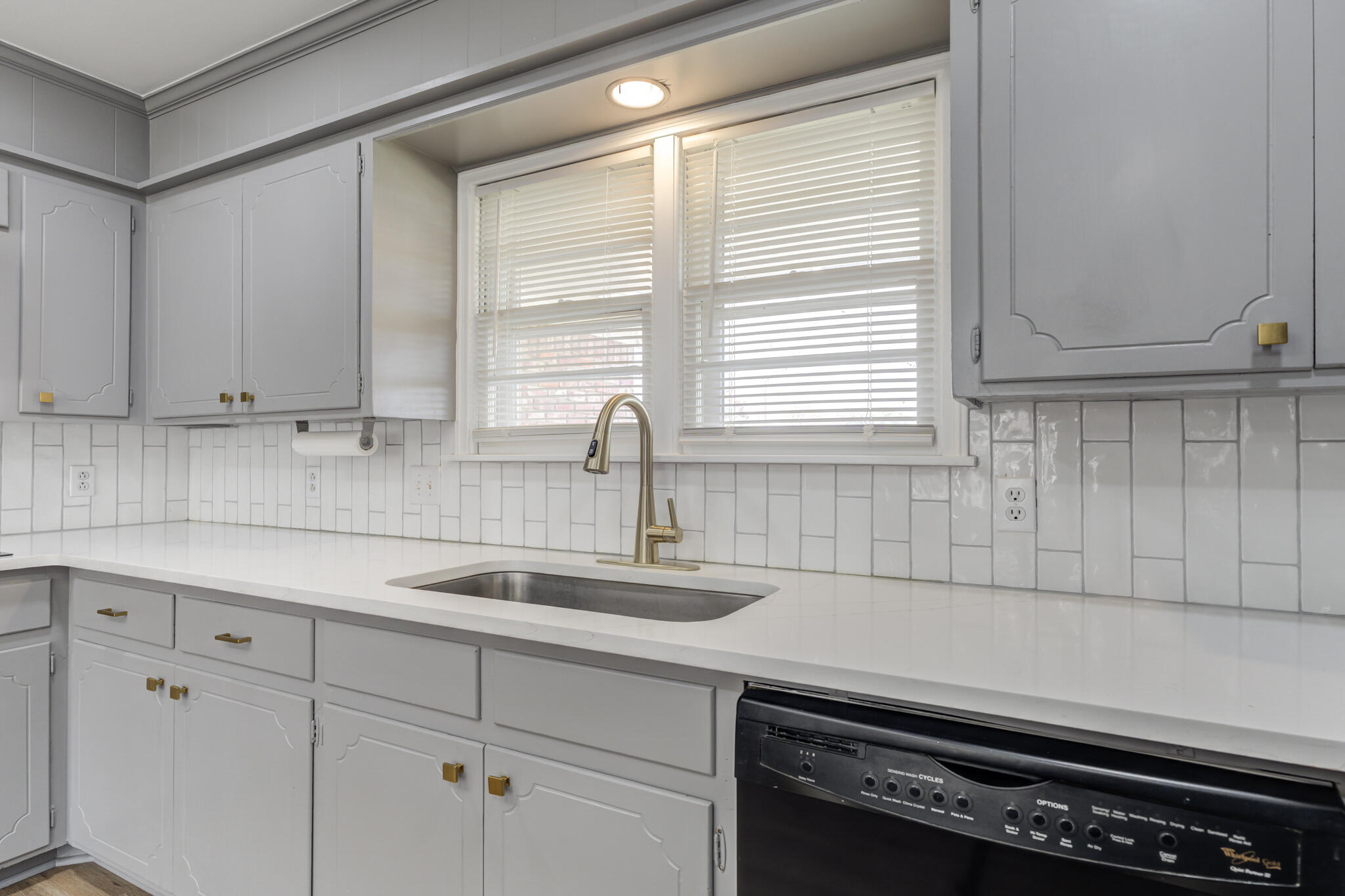 3023 66th Street Lubbock, TX 79413 - Photo 6 of 40 a kitchen with appliances cabinets and a window