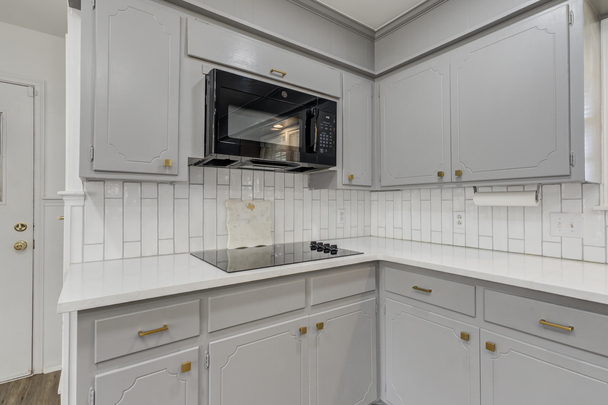 3023 66th Street Lubbock, TX 79413 - Photo 7 of 40 a kitchen with white cabinets stainless steel appliances and sink