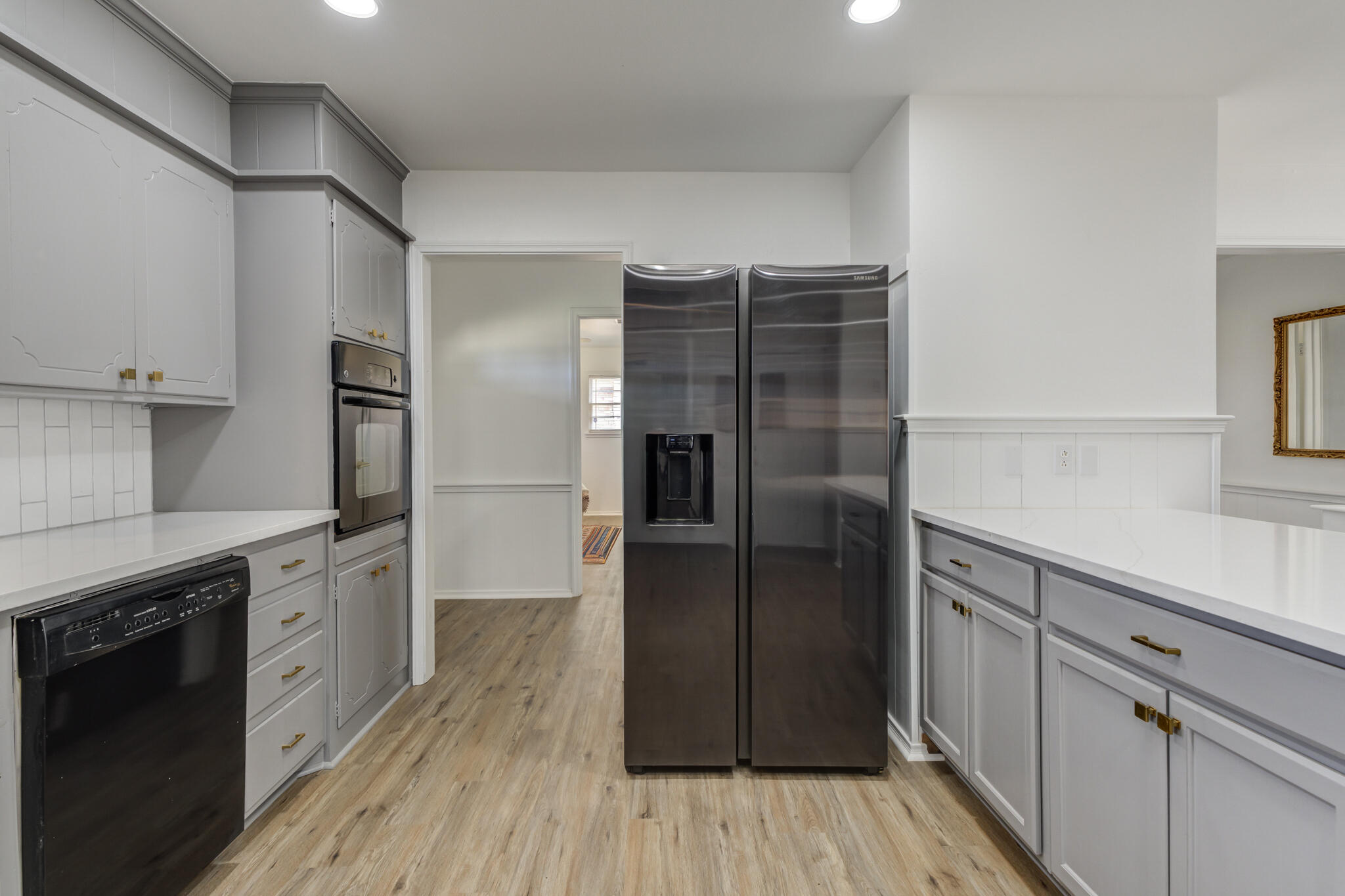 3023 66th Street Lubbock, TX 79413 - Photo 9 of 40 a kitchen with stainless steel appliances a refrigerator and a stove top oven