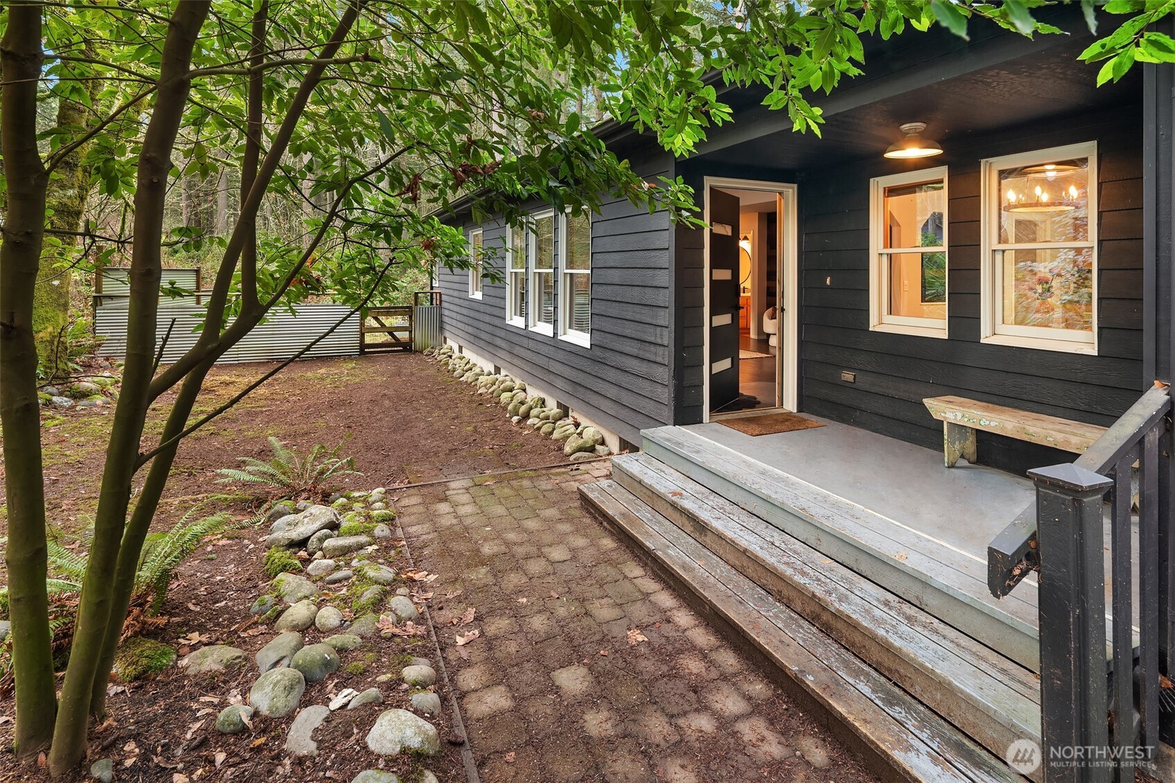 a view of backyard with deck and outdoor seating