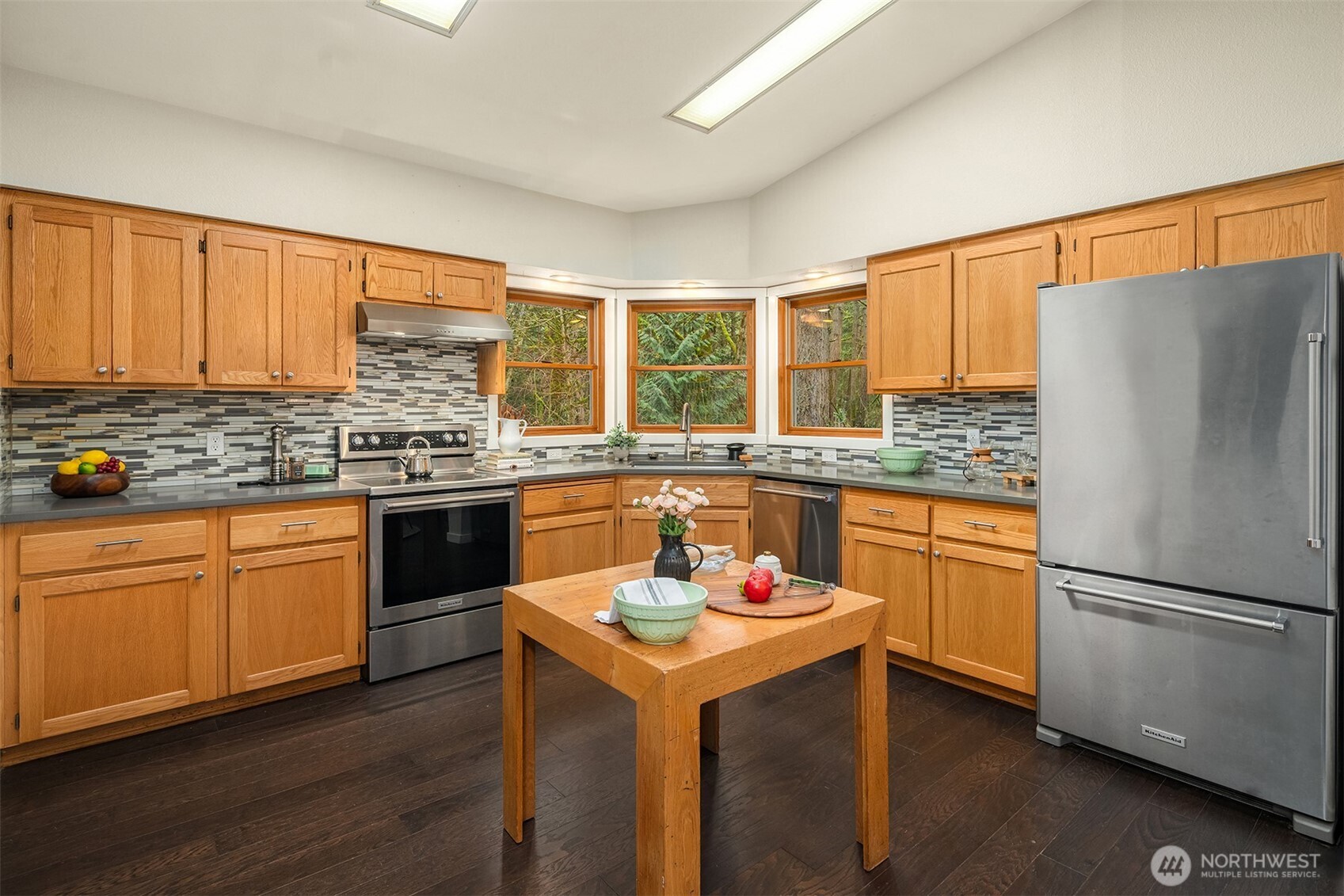 12908 Southwest 244th Place Vashon, WA 98070 - Photo 12 of 30 a kitchen with granite countertop stainless steel appliances a stove sink and refrigerator
