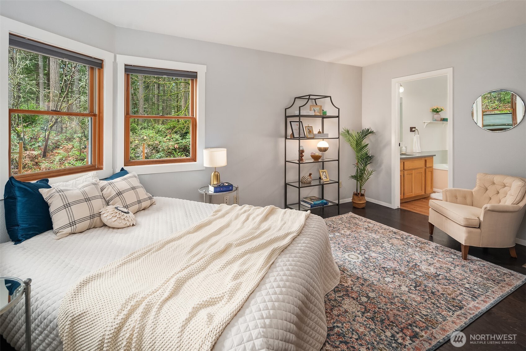 12908 Southwest 244th Place Vashon, WA 98070 - Photo 20 of 30 a bedroom with a large bed and wooden floor