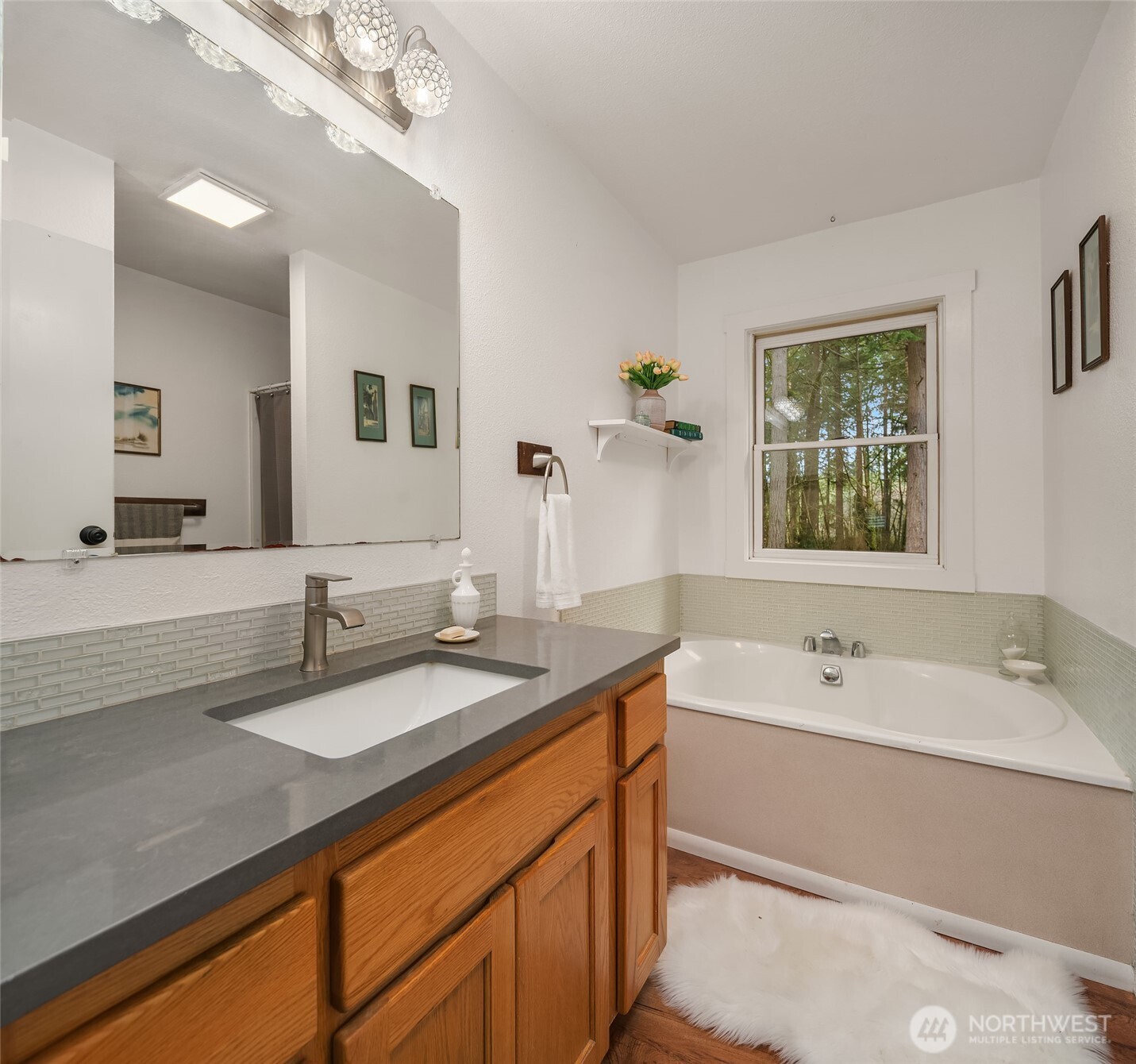 12908 Southwest 244th Place Vashon, WA 98070 - Photo 21 of 30 a bathroom with a sink double vanity granite tub and a mirror