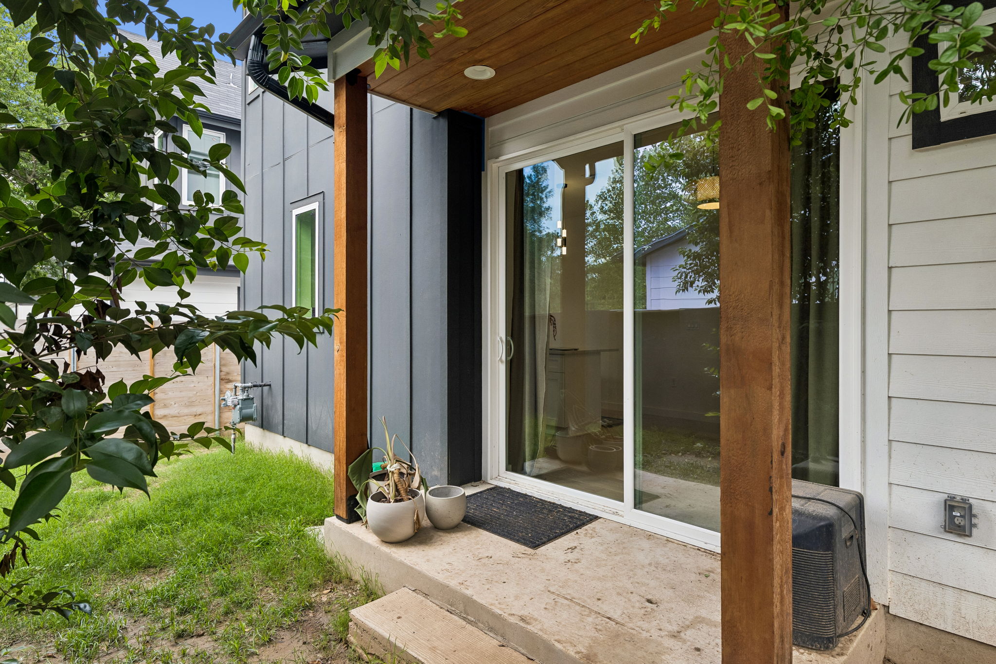 5305 Ledesma Road, Unit 1 Austin, TX 78721 - Photo 23 of 26 A shot of the rear exterior or private backyard space. The deck provides an ideal spot for morning coffee or evening BBQing, surrounded by a high privacy fence that creates a secluded urban retreat.