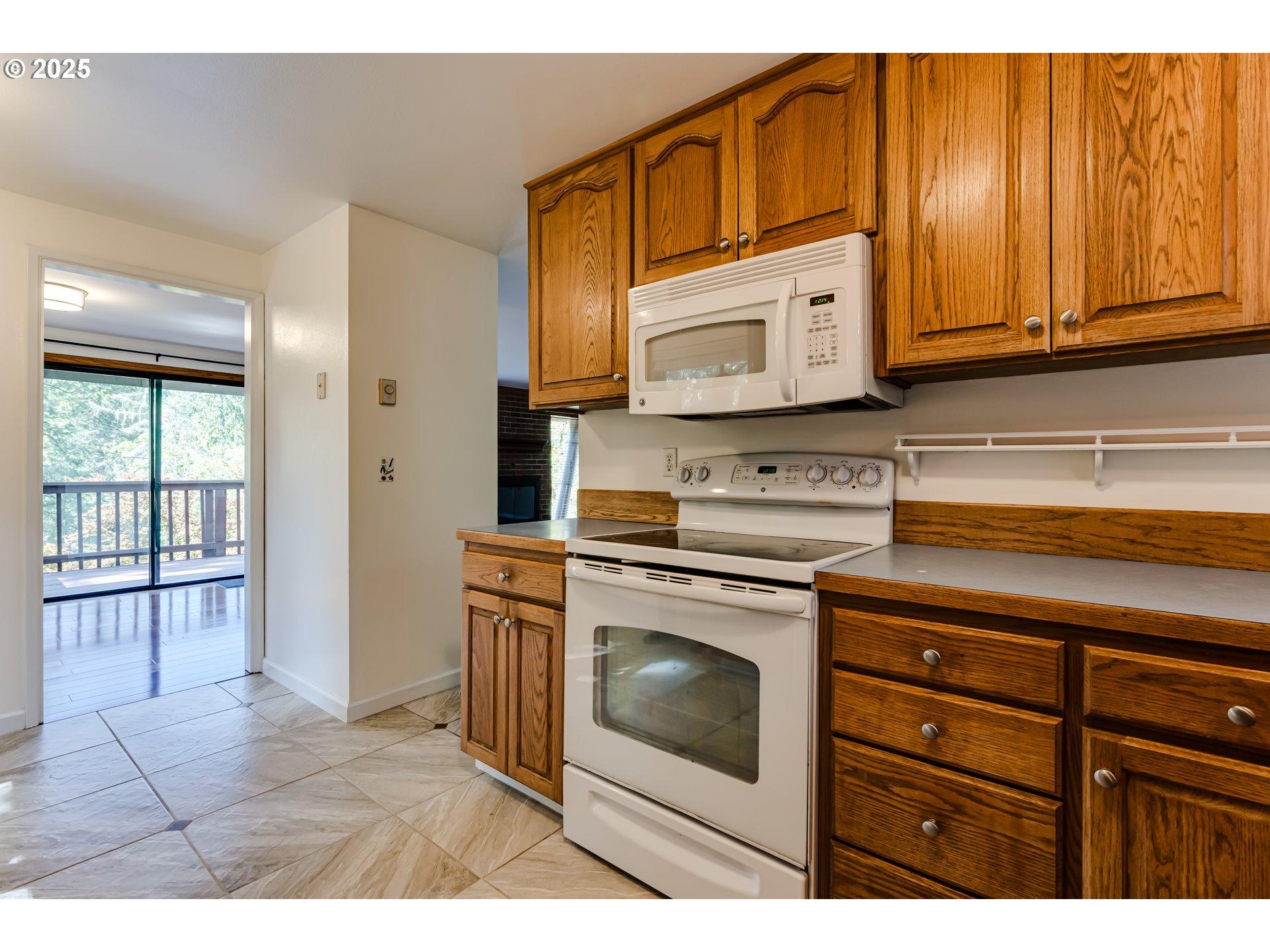 5140 Saratoga Street Eugene, OR 97405 - Photo 15 of 45 a kitchen with stainless steel appliances granite countertop a stove a sink and a microwave