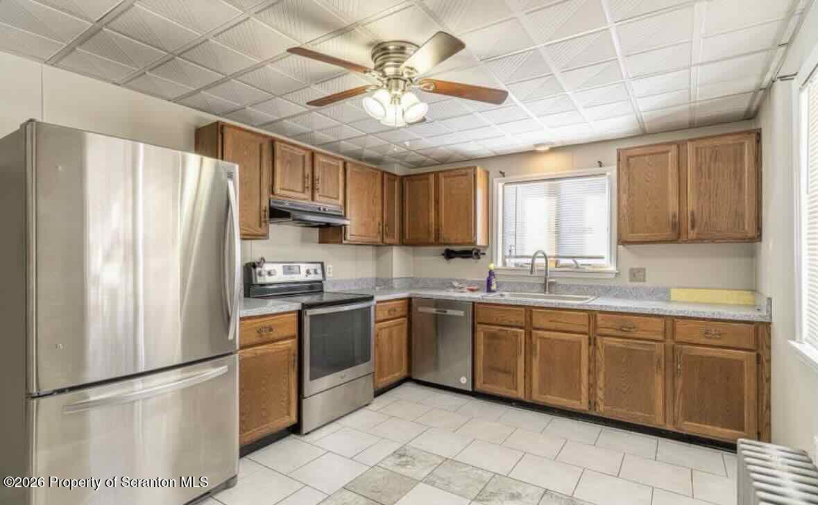112 East Grove Street Taylor, PA 18517 - Photo 2 of 11 a kitchen with stainless steel appliances granite countertop a refrigerator sink and cabinets