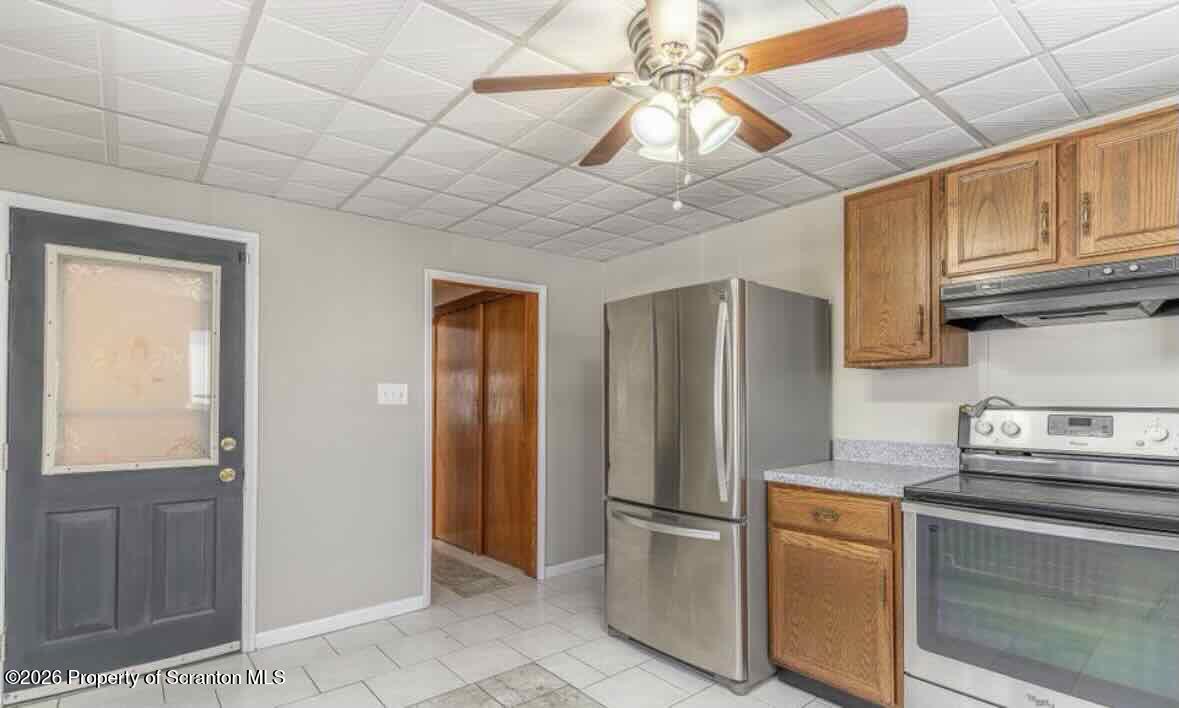 112 East Grove Street Taylor, PA 18517 - Photo 4 of 11 a kitchen with stainless steel appliances granite countertop a refrigerator a sink and dishwasher