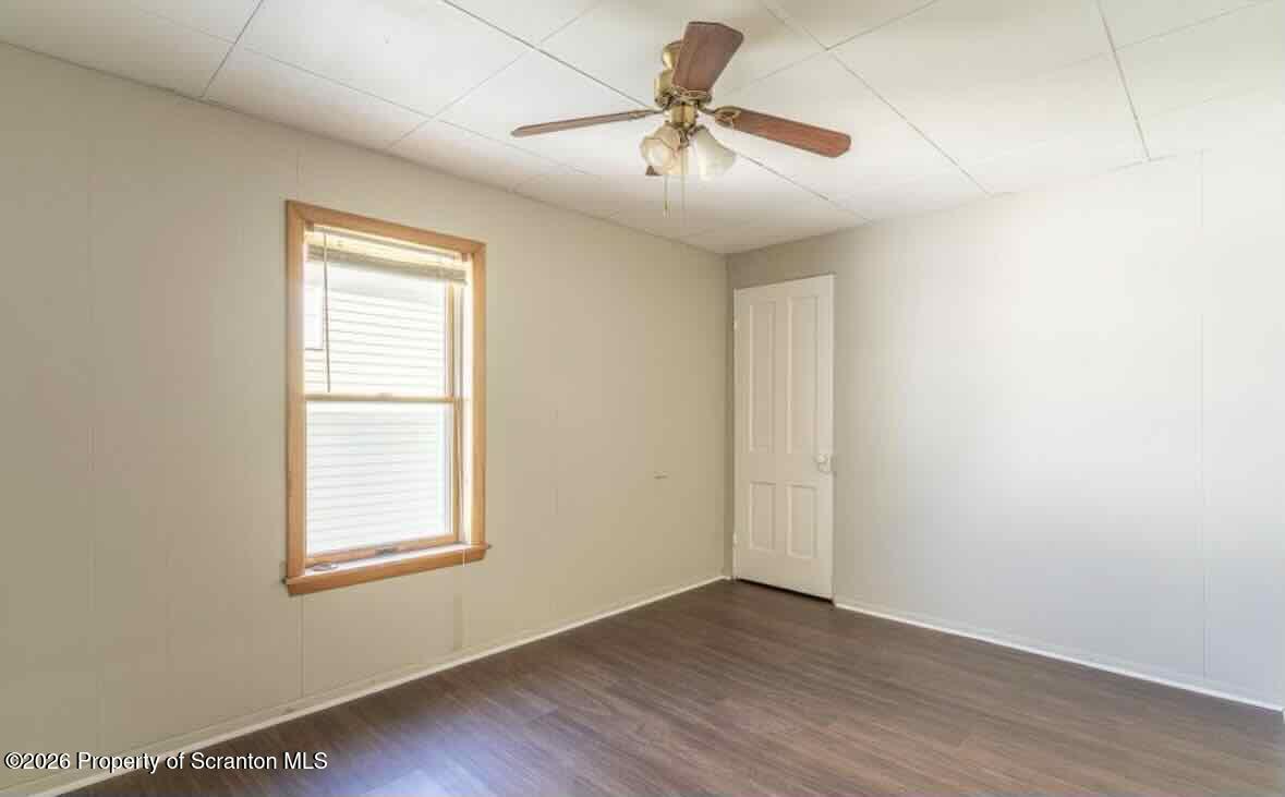 112 East Grove Street Taylor, PA 18517 - Photo 6 of 11 an empty room with wooden floor fan and windows
