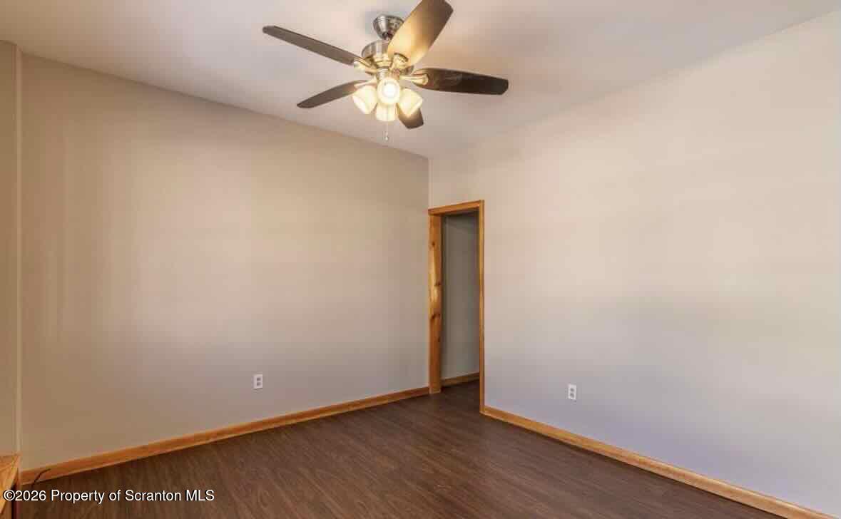 112 East Grove Street Taylor, PA 18517 - Photo 7 of 11 an empty room with wooden floor and a ceiling fan