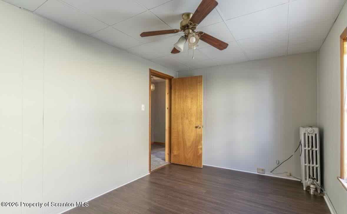 112 East Grove Street Taylor, PA 18517 - Photo 9 of 11 a view of an empty room with wooden floor