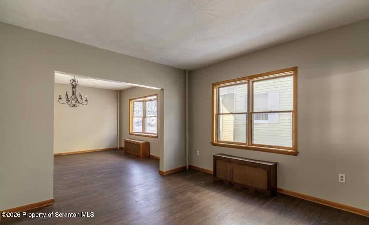 112 East Grove Street Taylor, PA 18517 - Photo 10 of 11 an empty room with wooden floor and windows