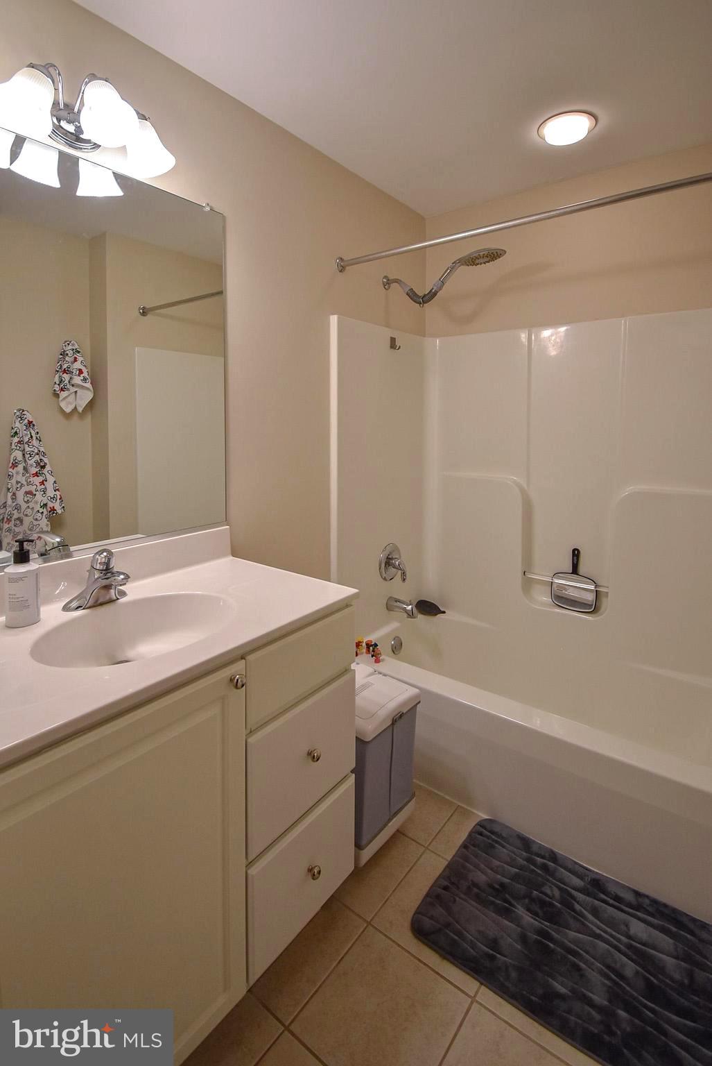 586 Wharton Boulevard Exton, PA 19341 - Photo 22 of 28 a bathroom with a tub sink toilet and a mirror