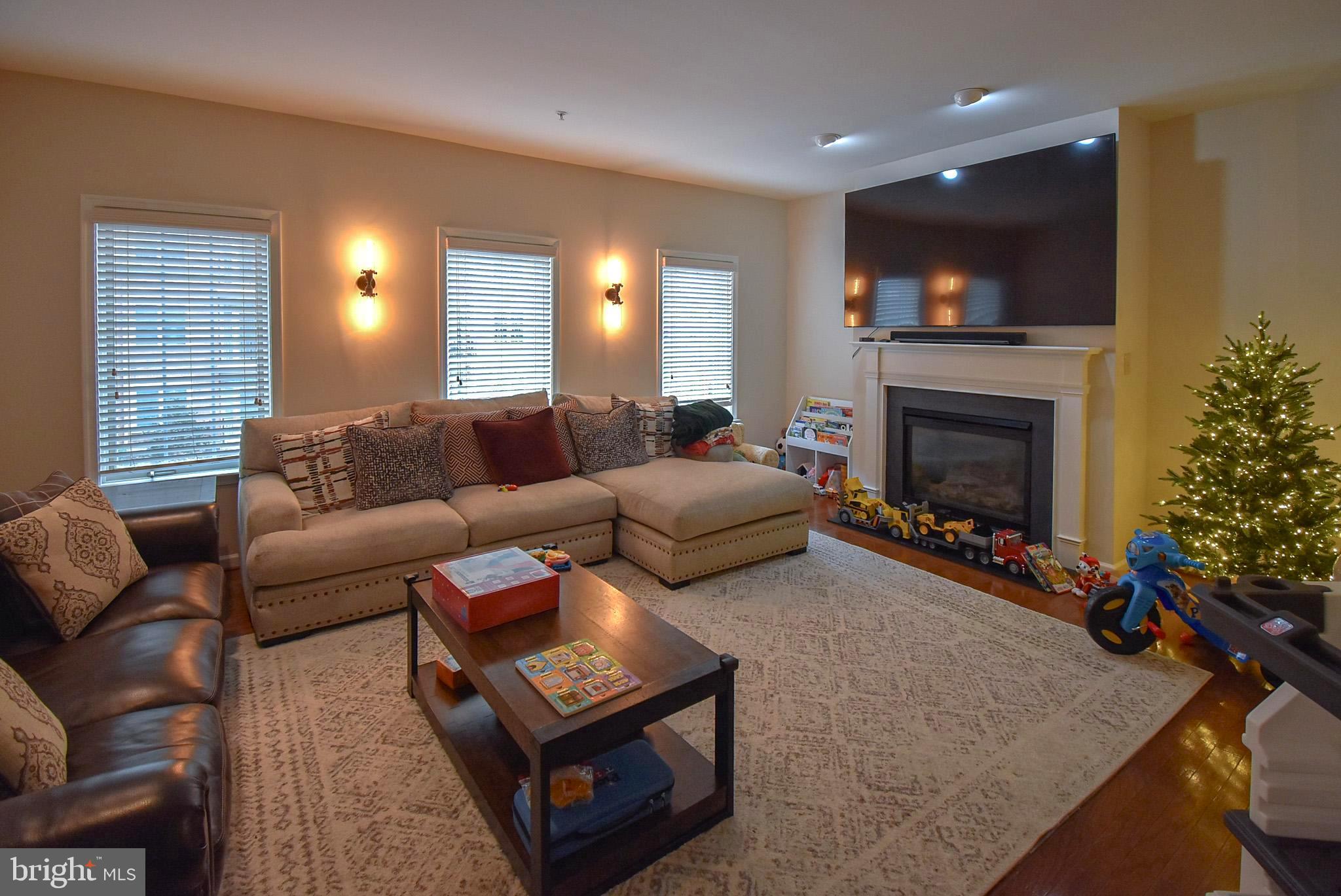 586 Wharton Boulevard Exton, PA 19341 - Photo 3 of 28 a living room with furniture a flat screen tv and a fireplace